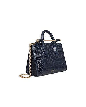 A blue handbag on a green background