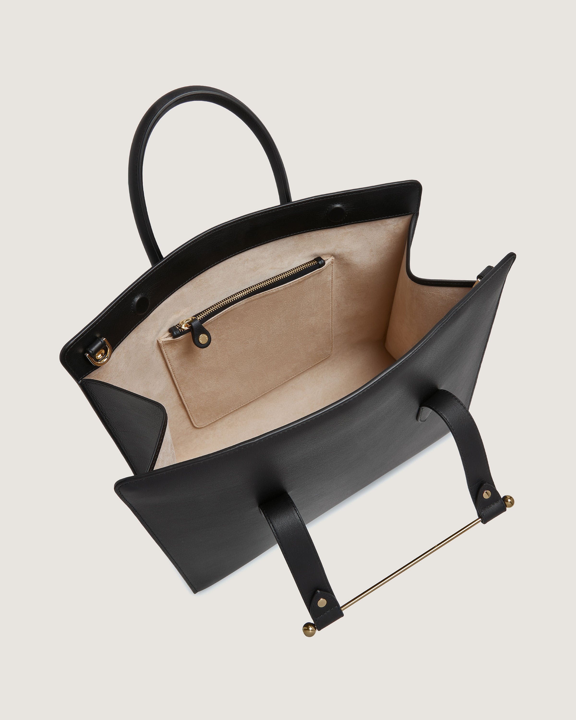 A black handbag with a long handle