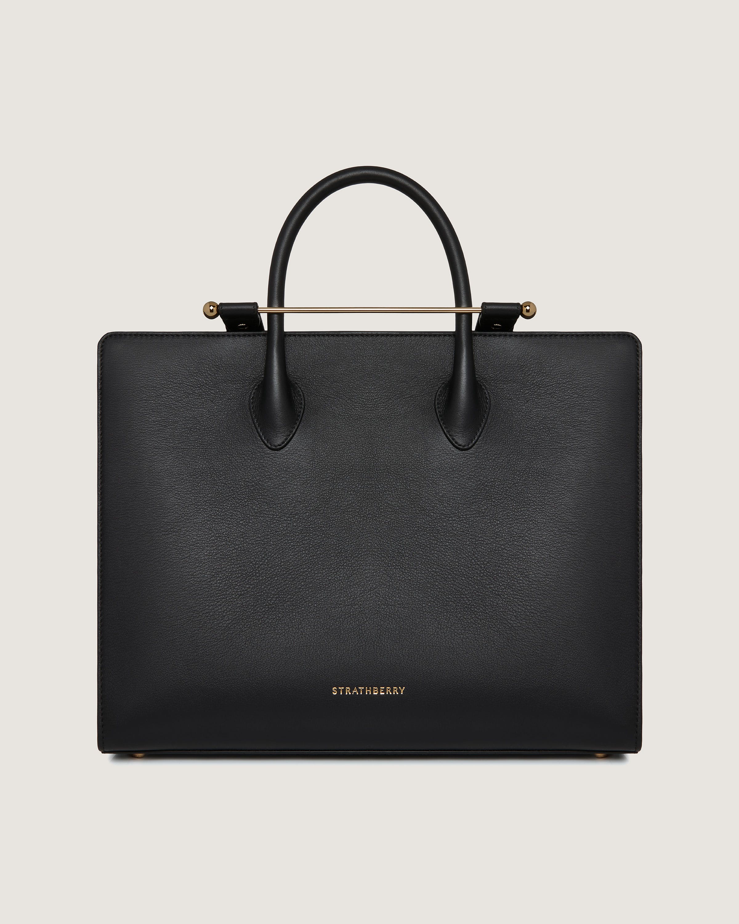 A black handbag with a gold handle