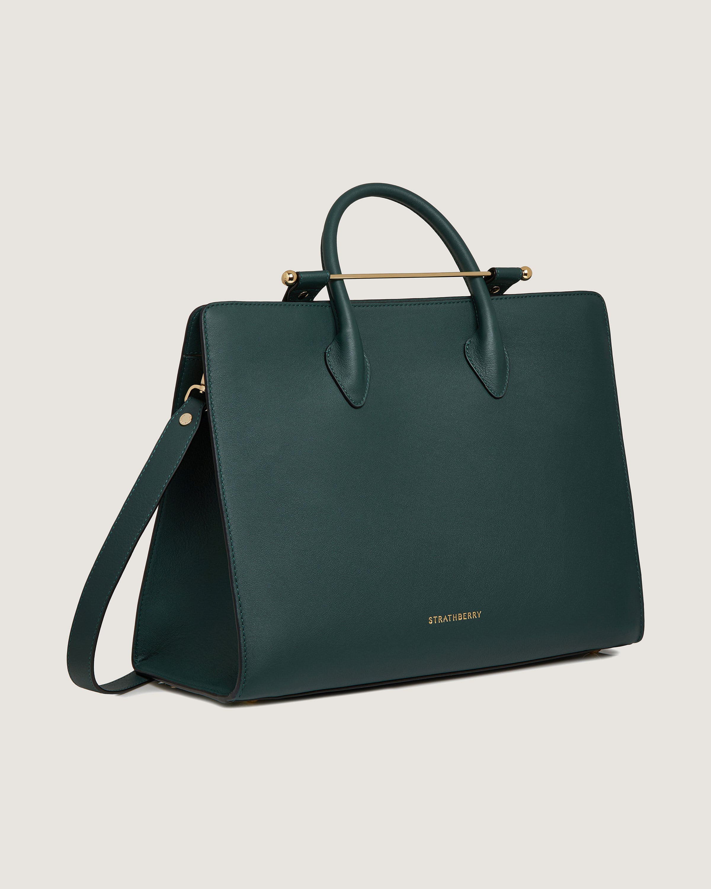 A green handbag with a gold handle