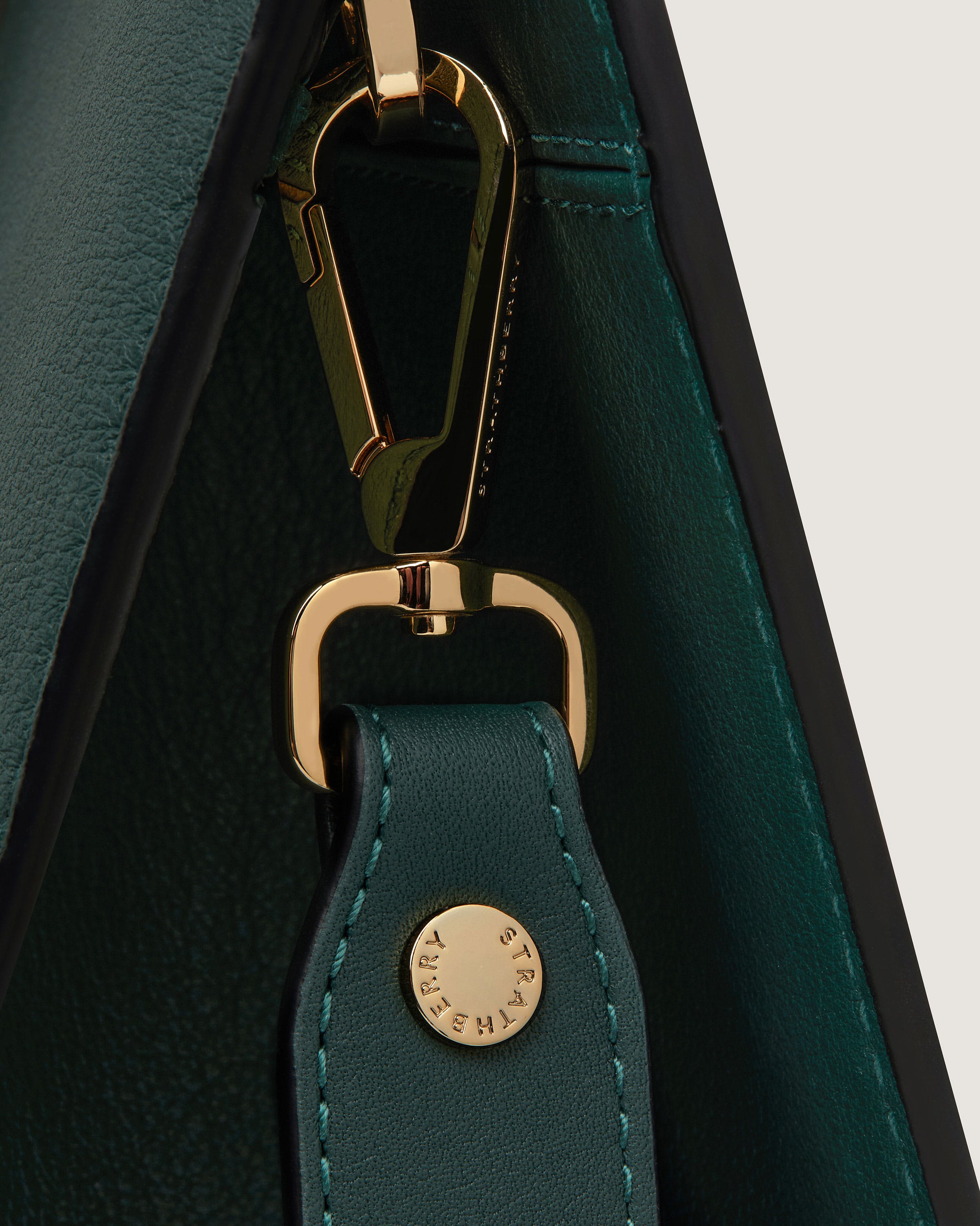 A close up of a key chain on a green bag