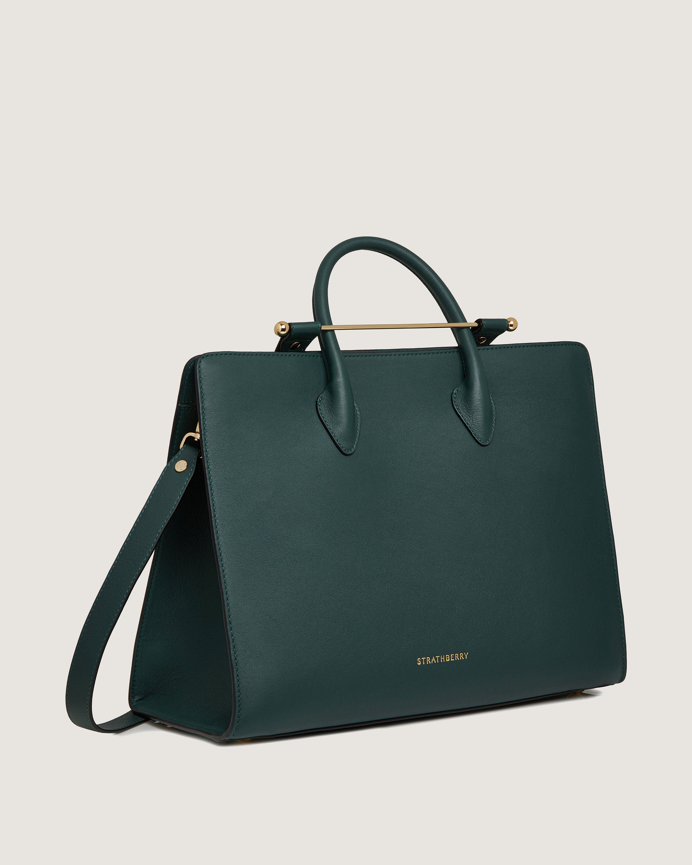 A green handbag with a gold handle