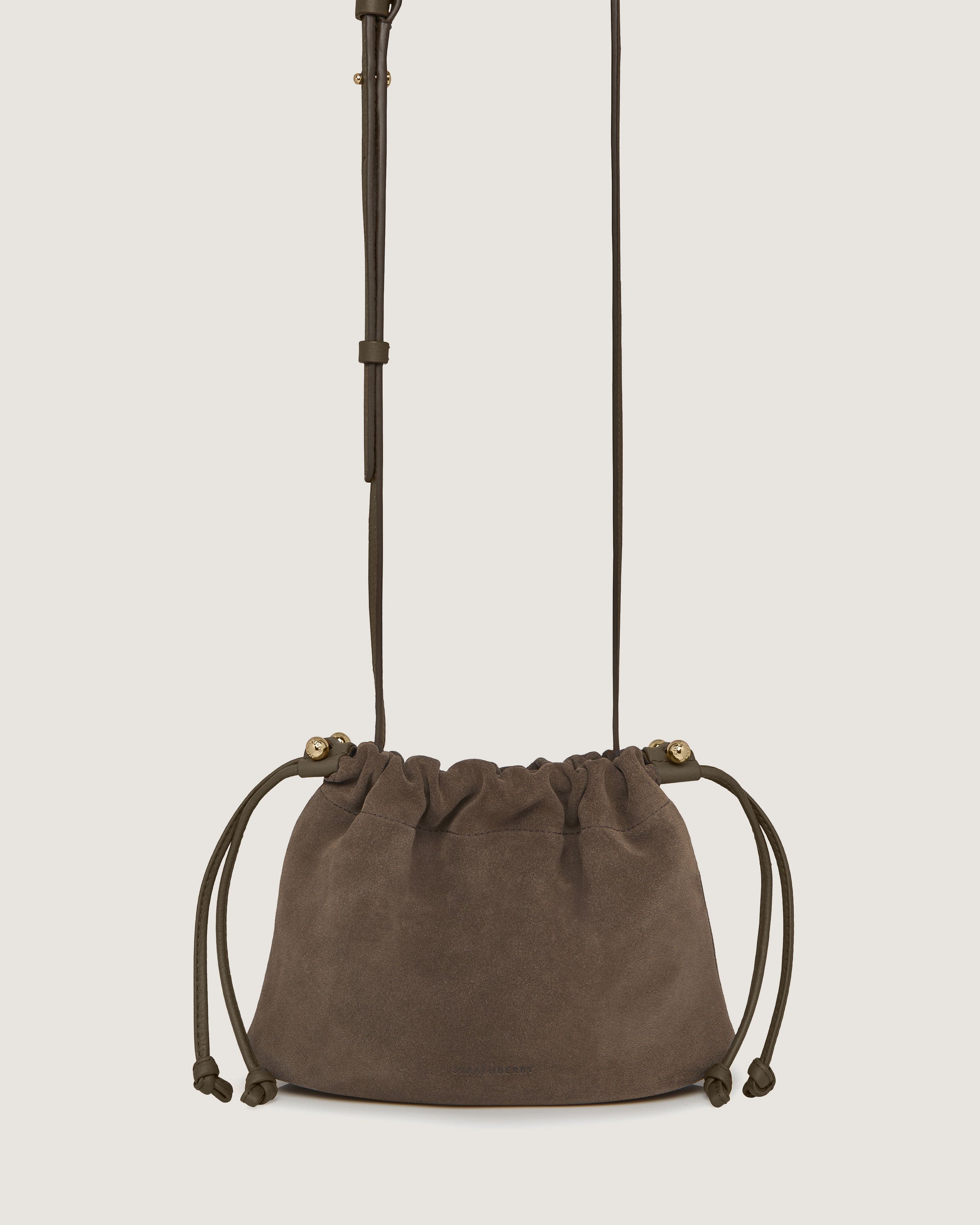 A brown suede bag hanging from a hook