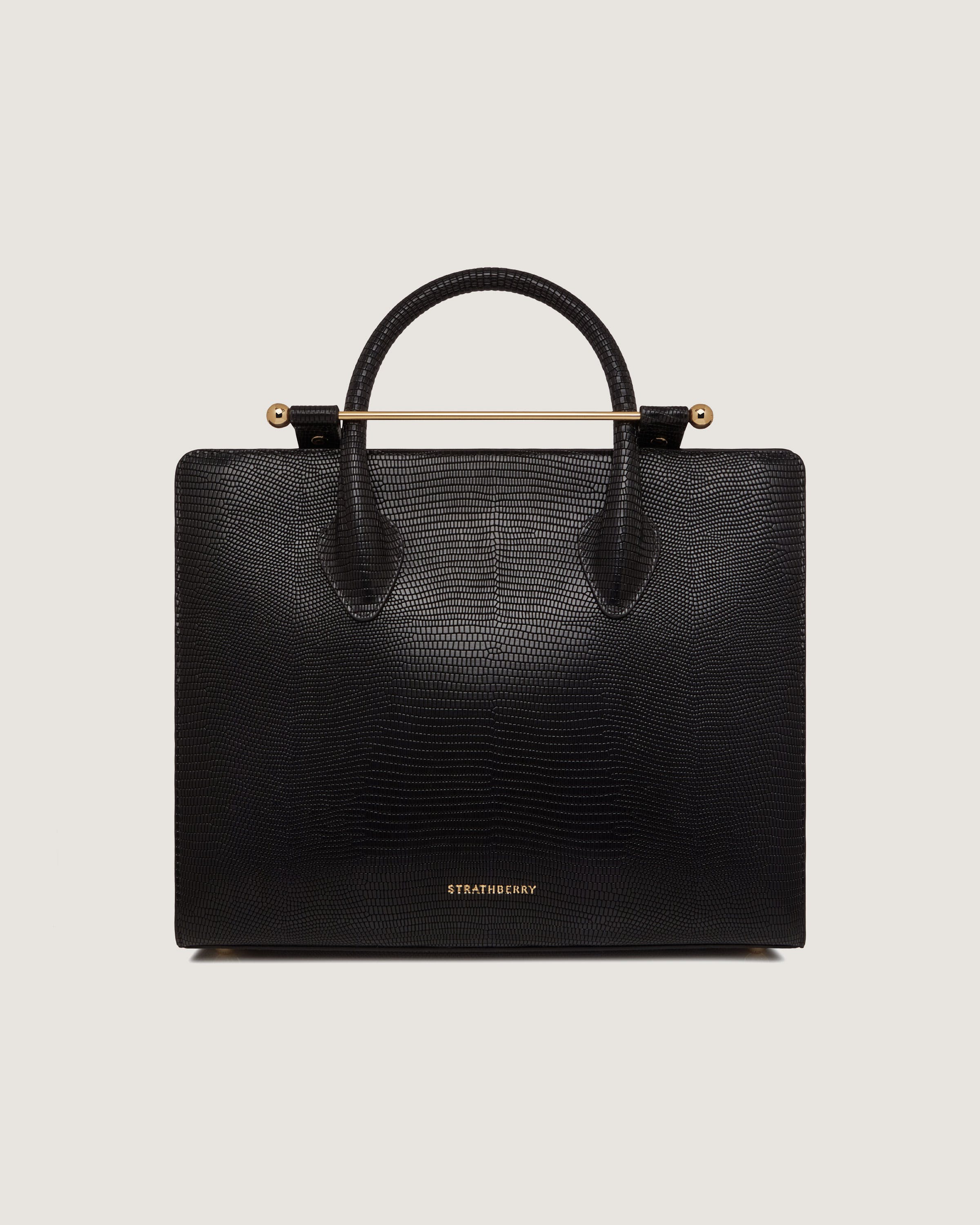 A black handbag with a gold handle