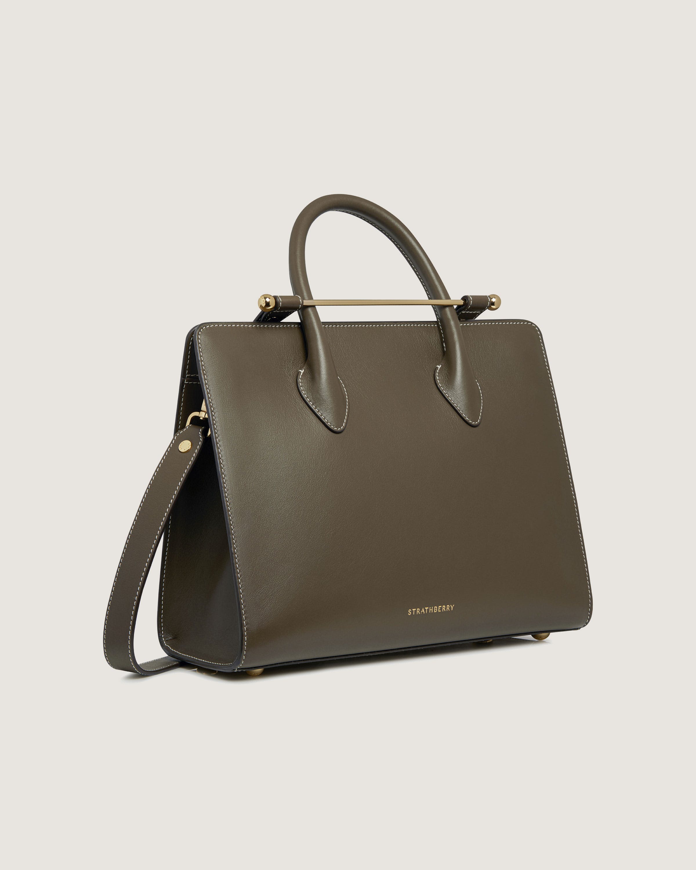 A brown handbag with a handle on a white background