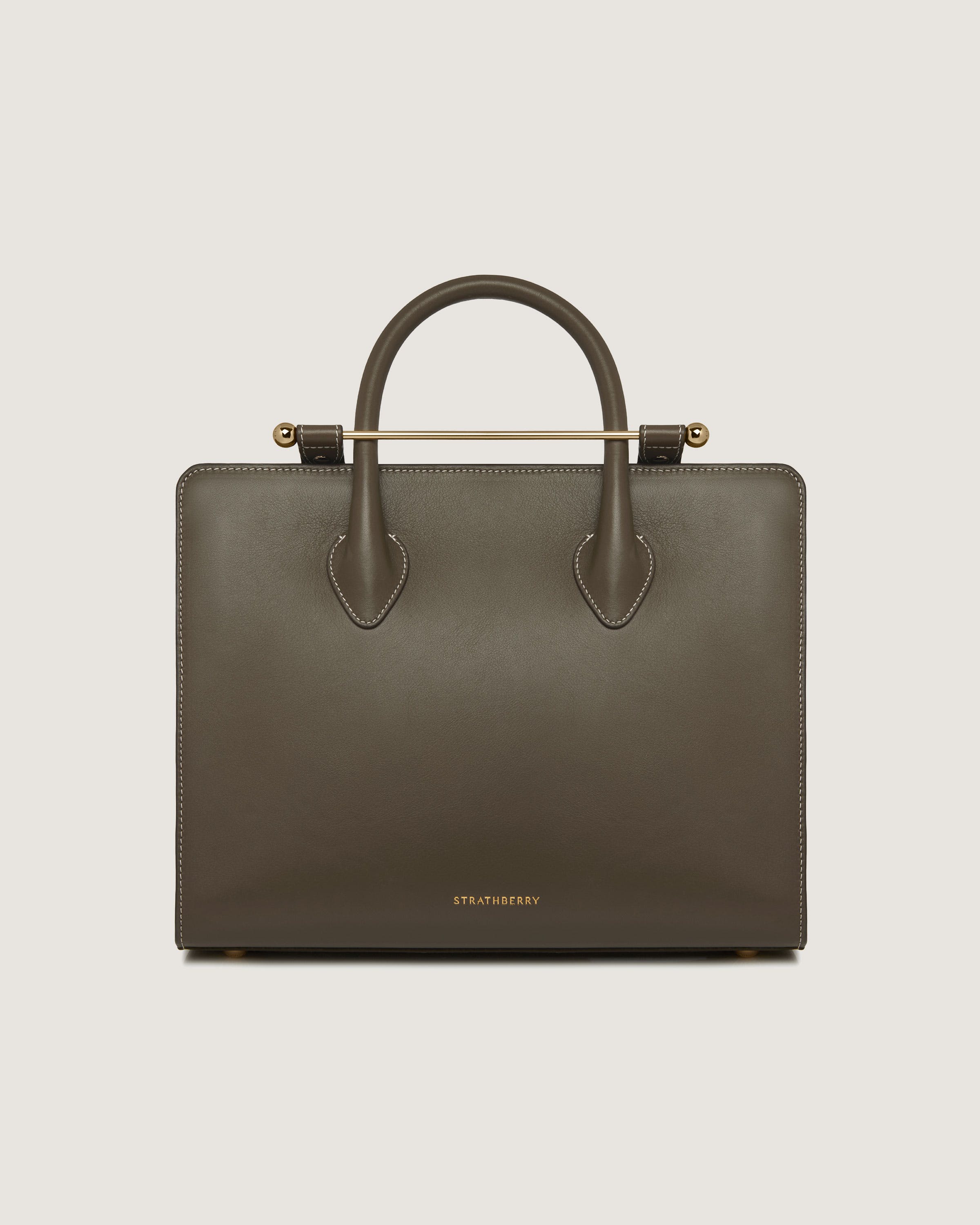 A brown leather handbag with a gold handle