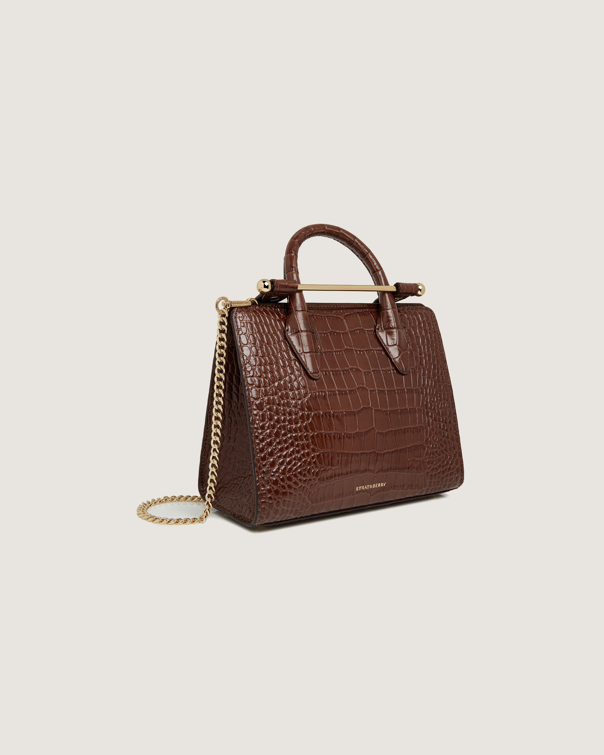 A brown handbag with a gold chain