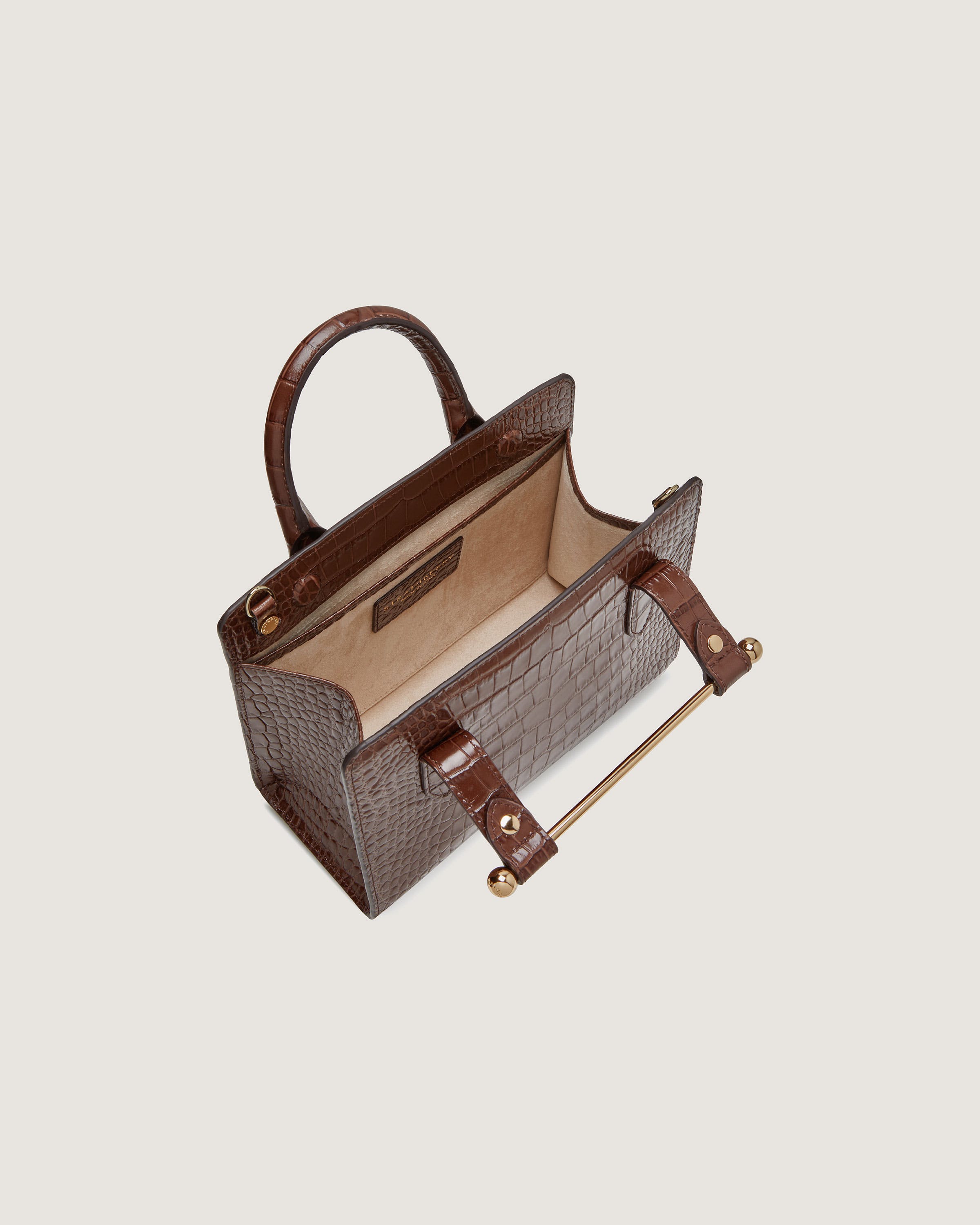 A brown handbag with a handle on a white background