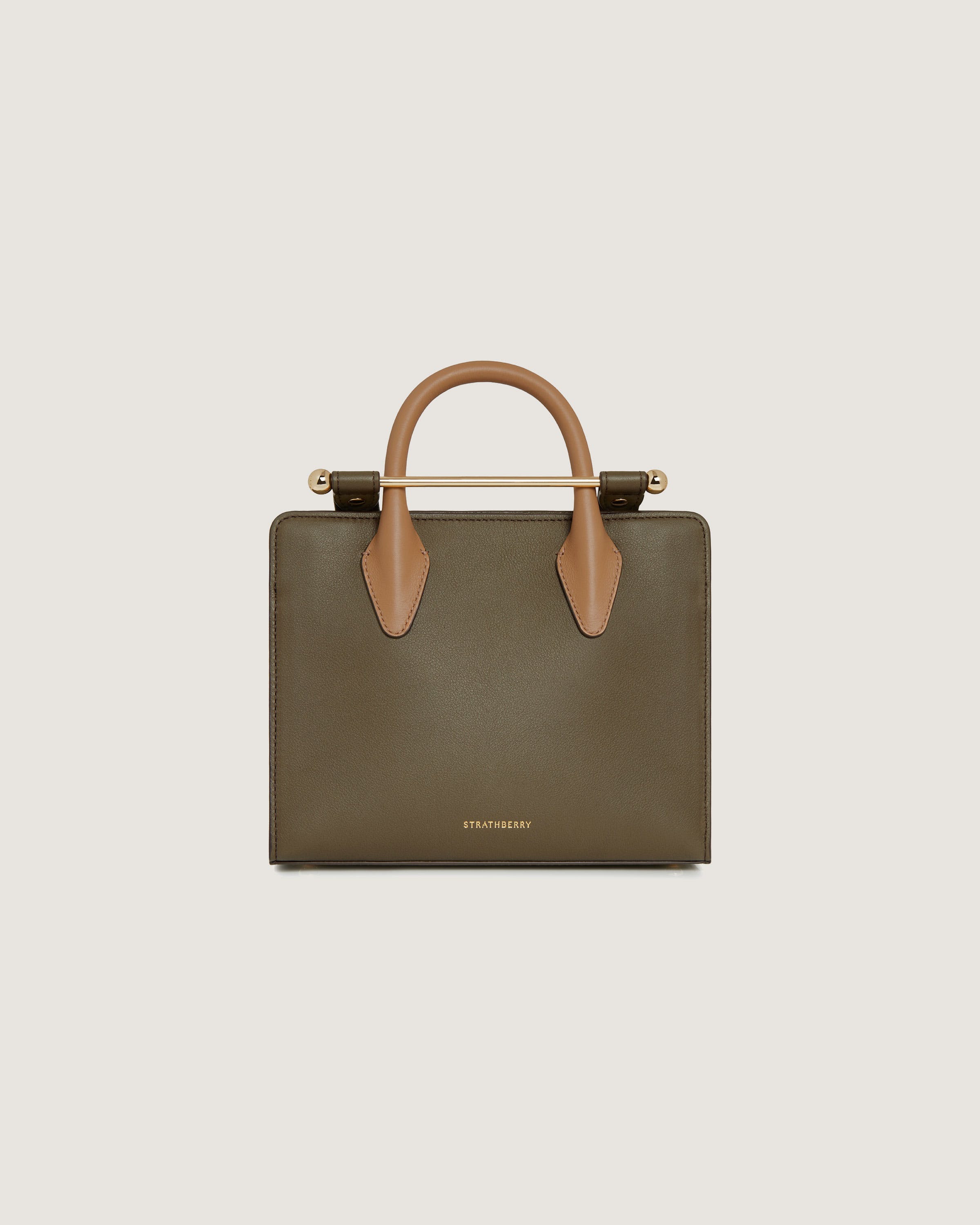 A brown and tan handbag on a white background