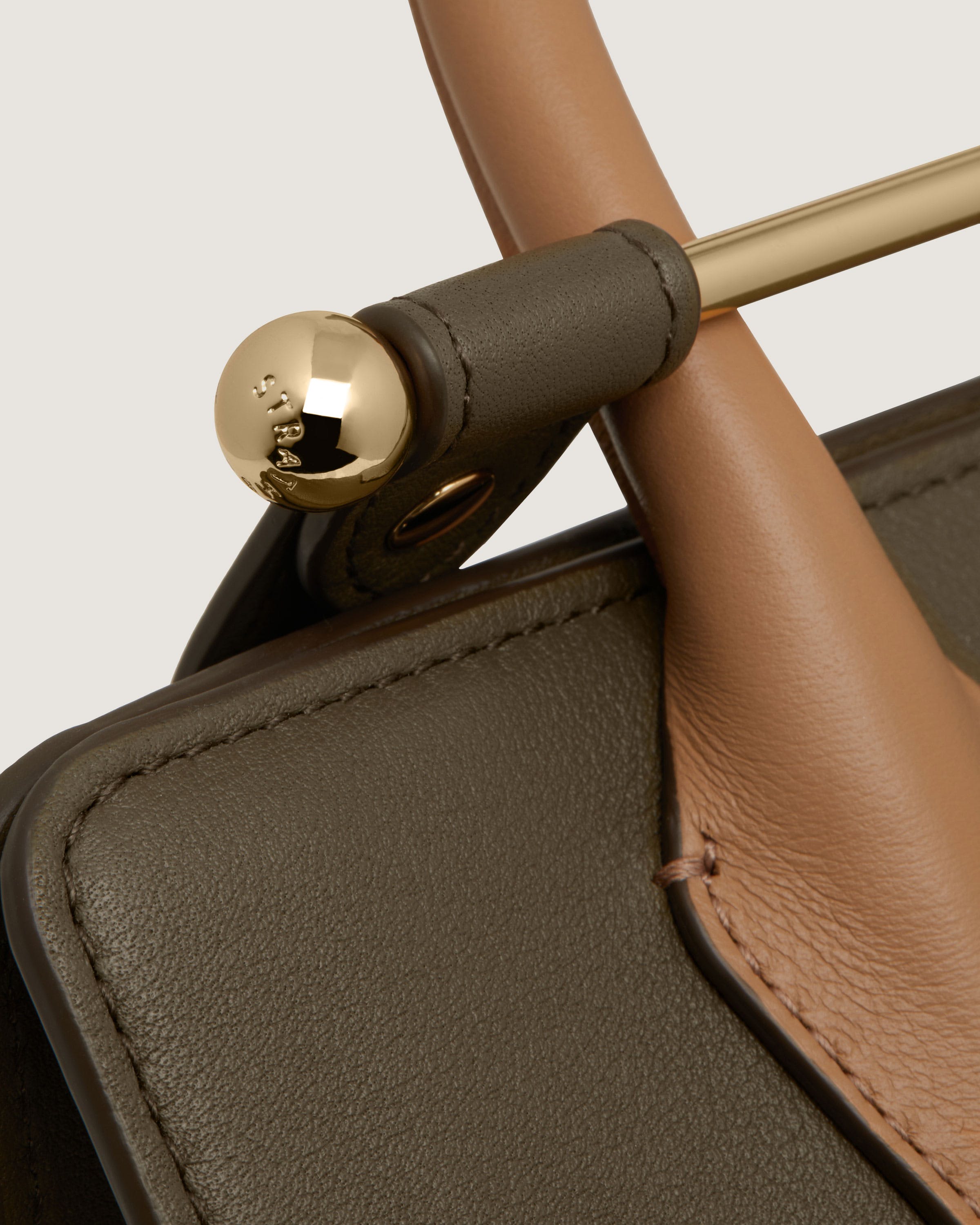 A close up of the handle of a purse