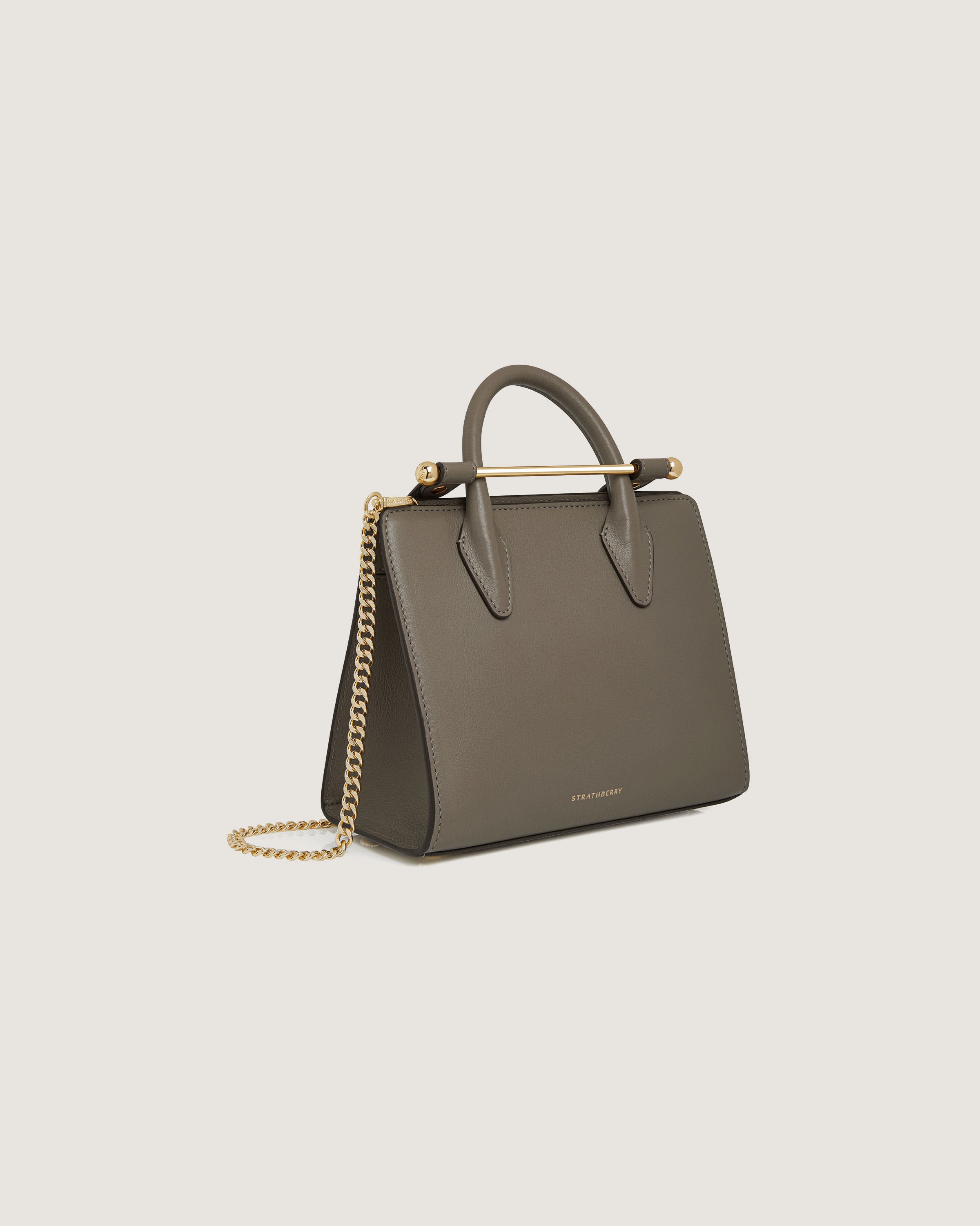 A small grey handbag with a gold chain