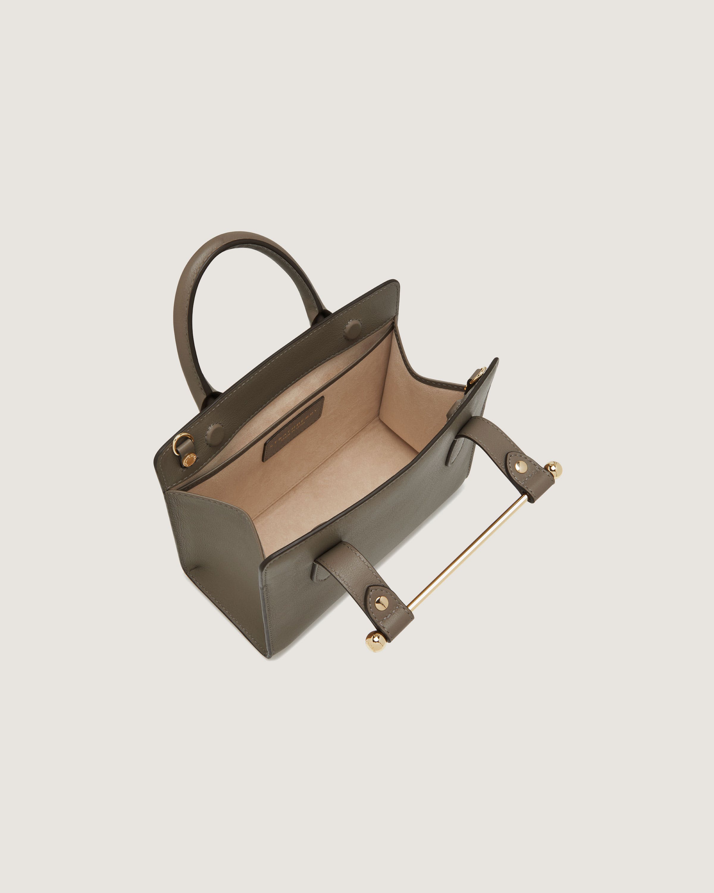 A brown handbag with a handle on a white background