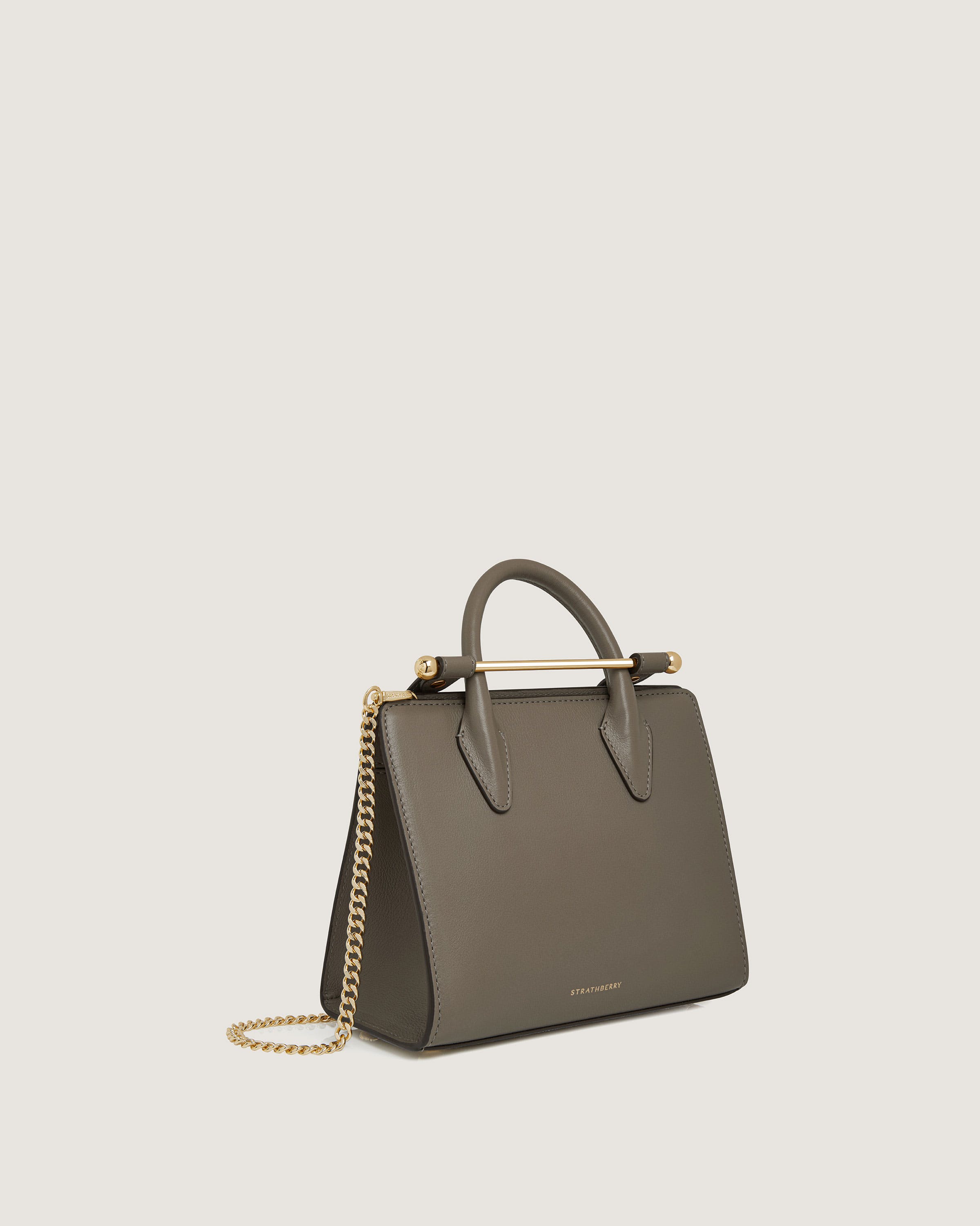 A small grey handbag with a gold chain