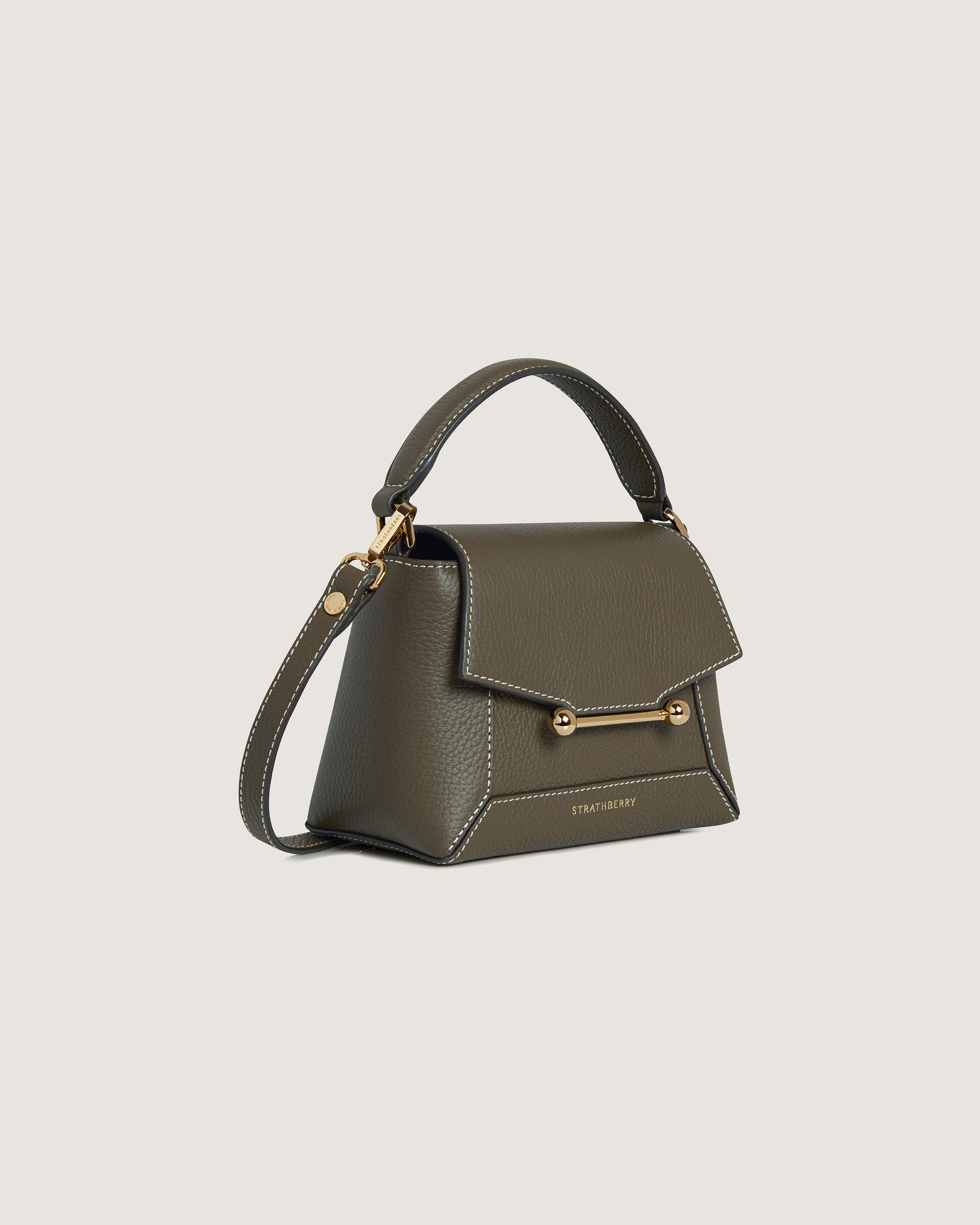 A small grey handbag with a gold handle