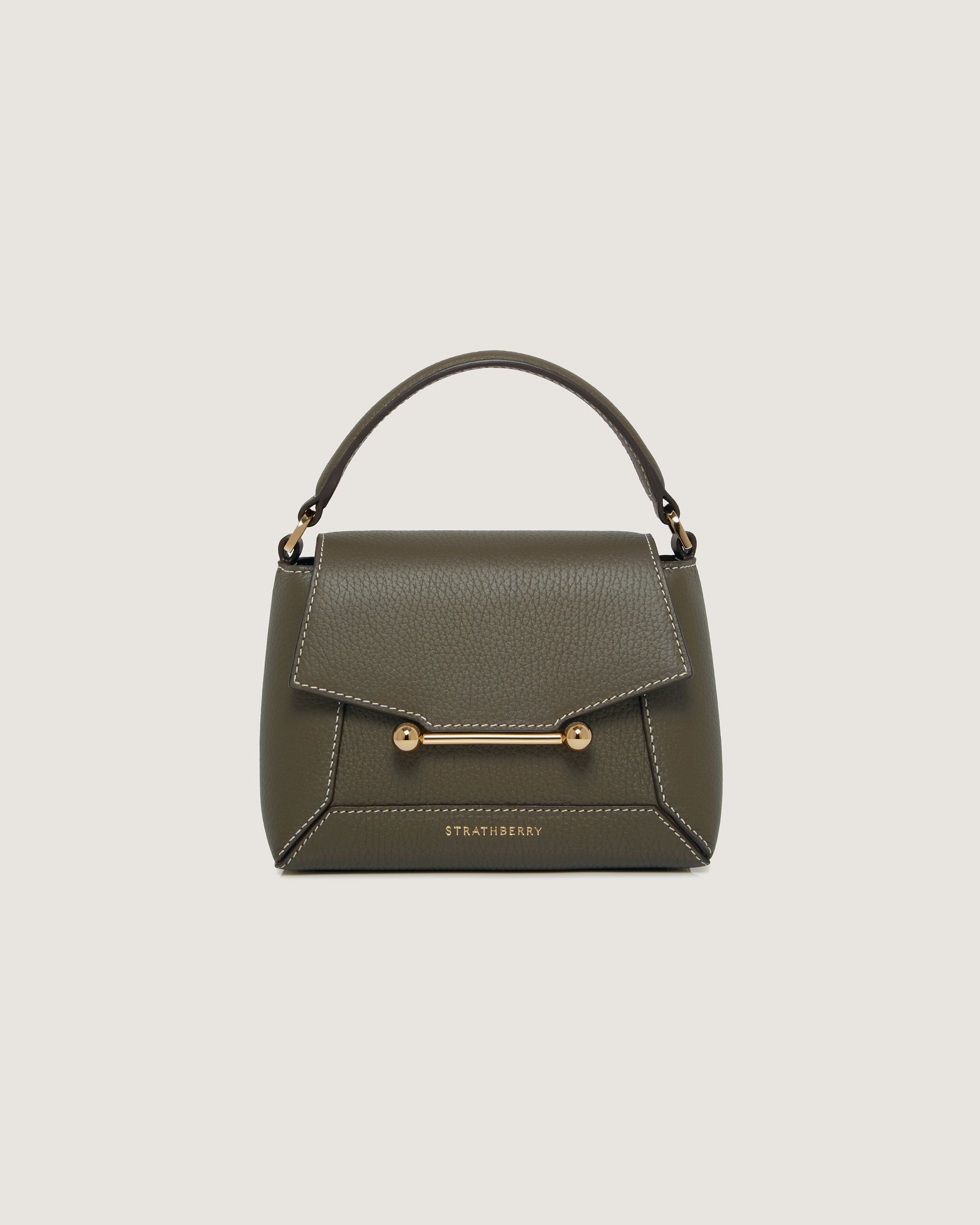 A green handbag with a gold handle