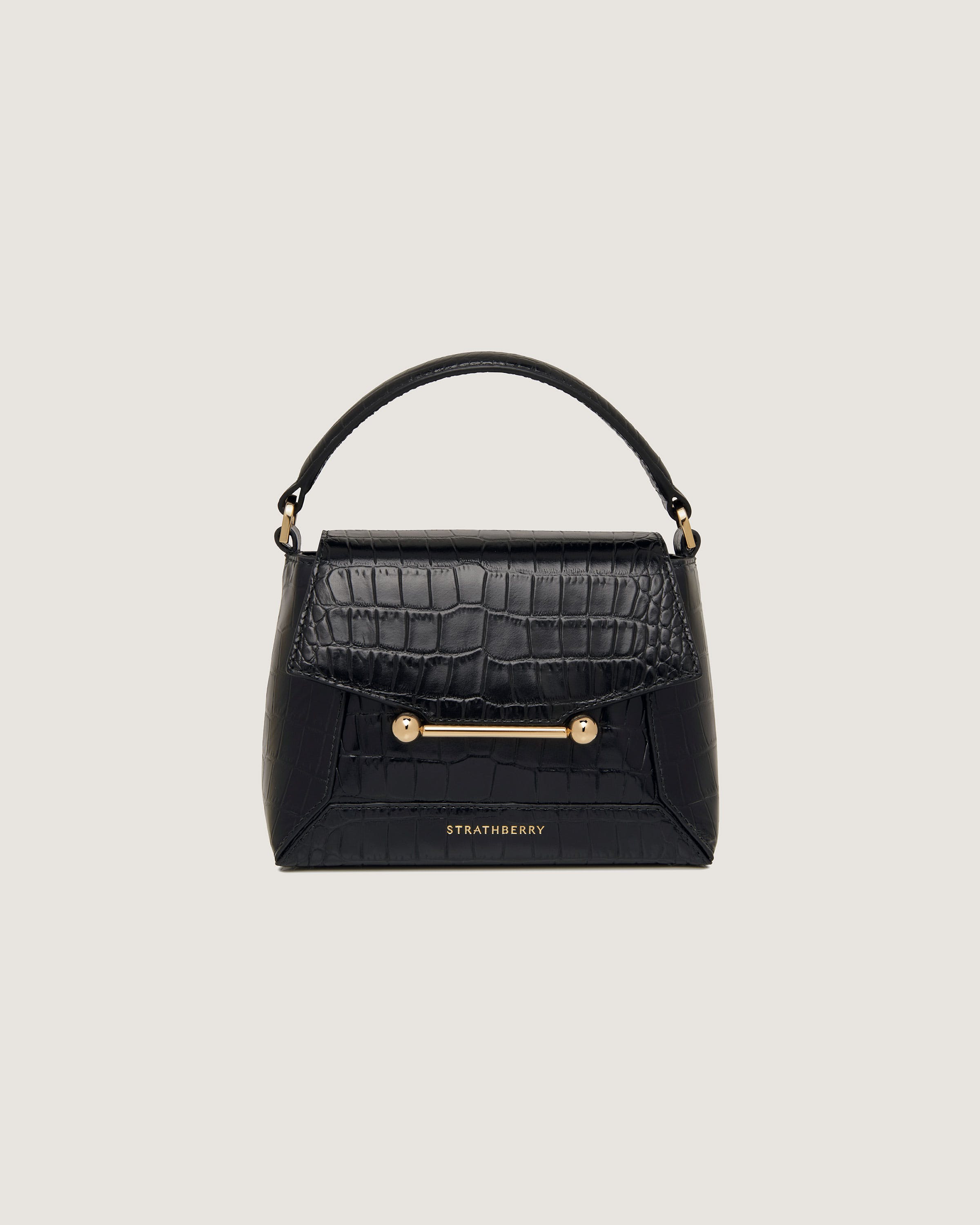 A black handbag with a gold handle