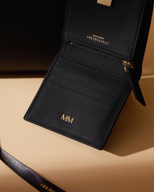 A black wallet sitting on top of a table