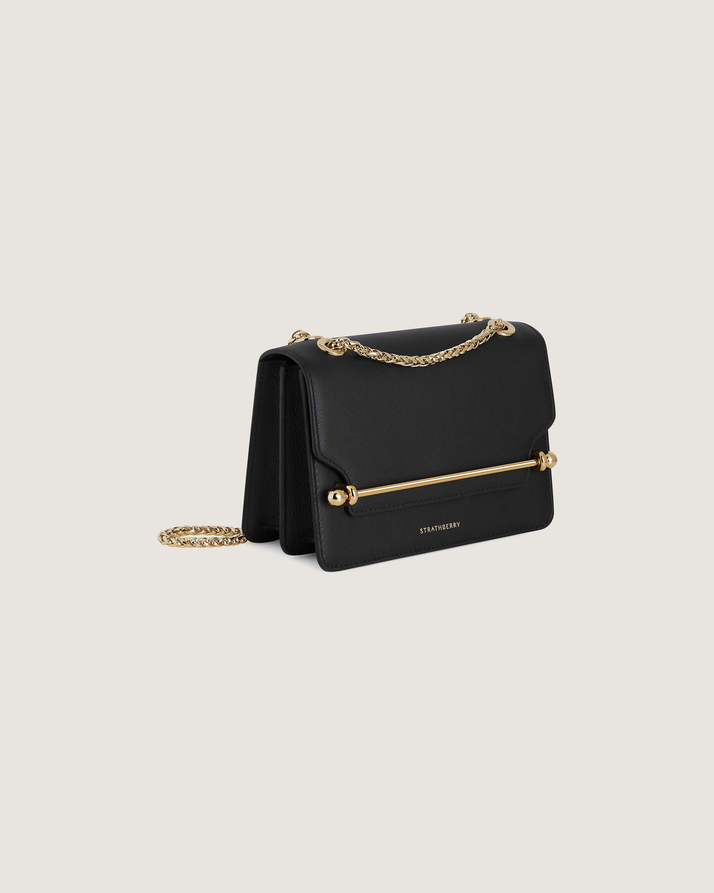 A black handbag with a gold chain strap