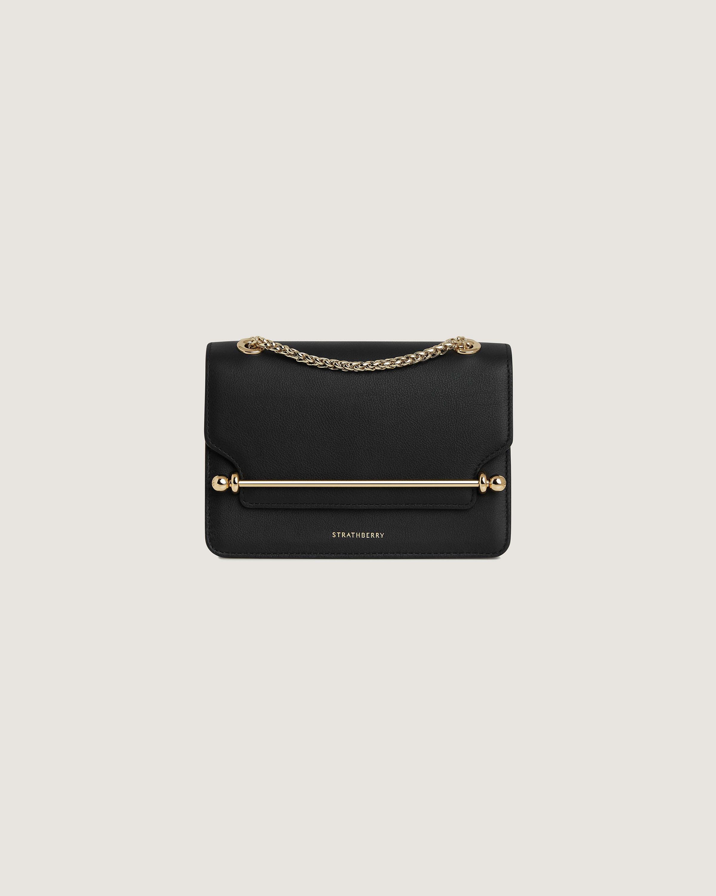 A black clutch bag with a gold chain