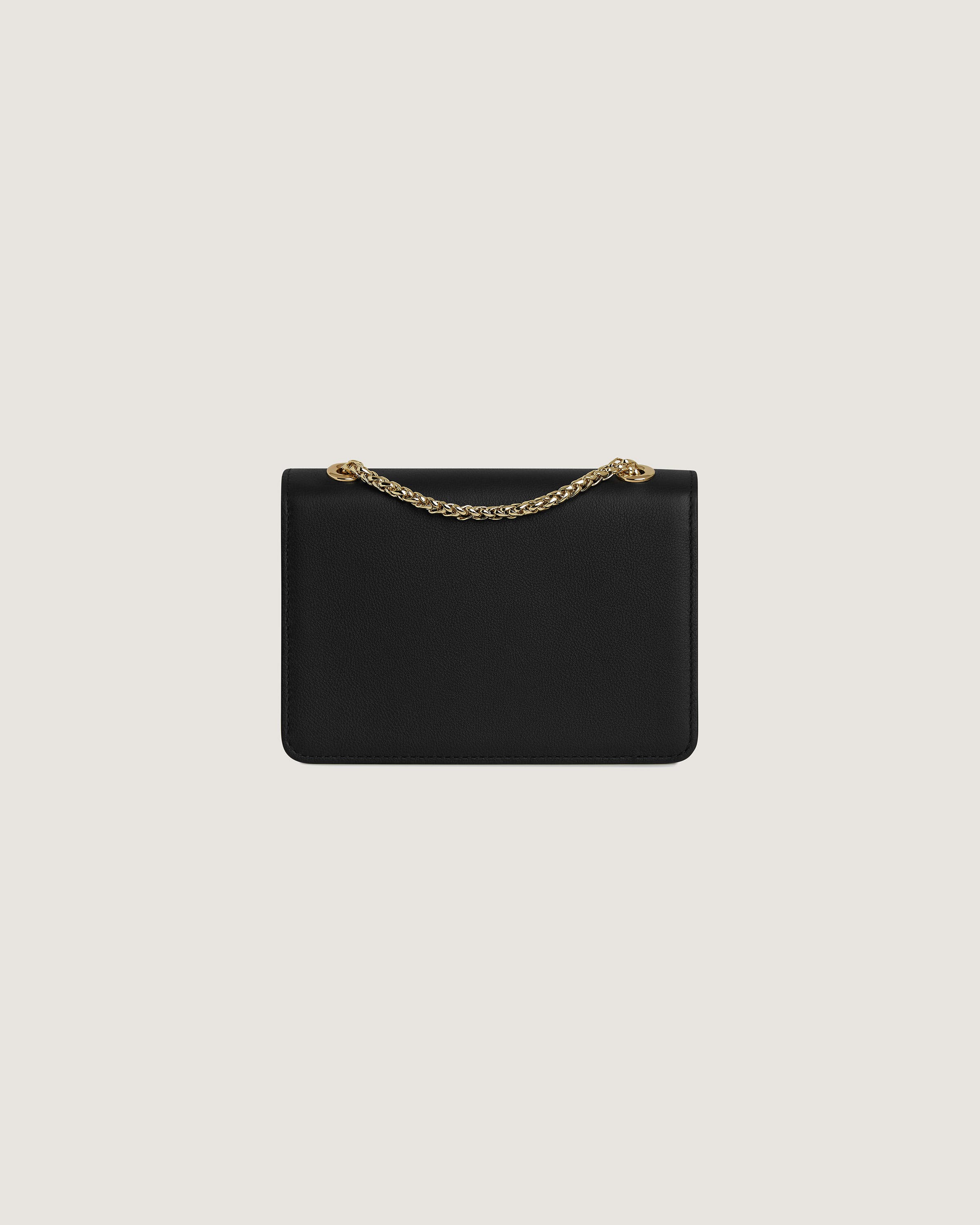 A black clutch bag with a gold chain