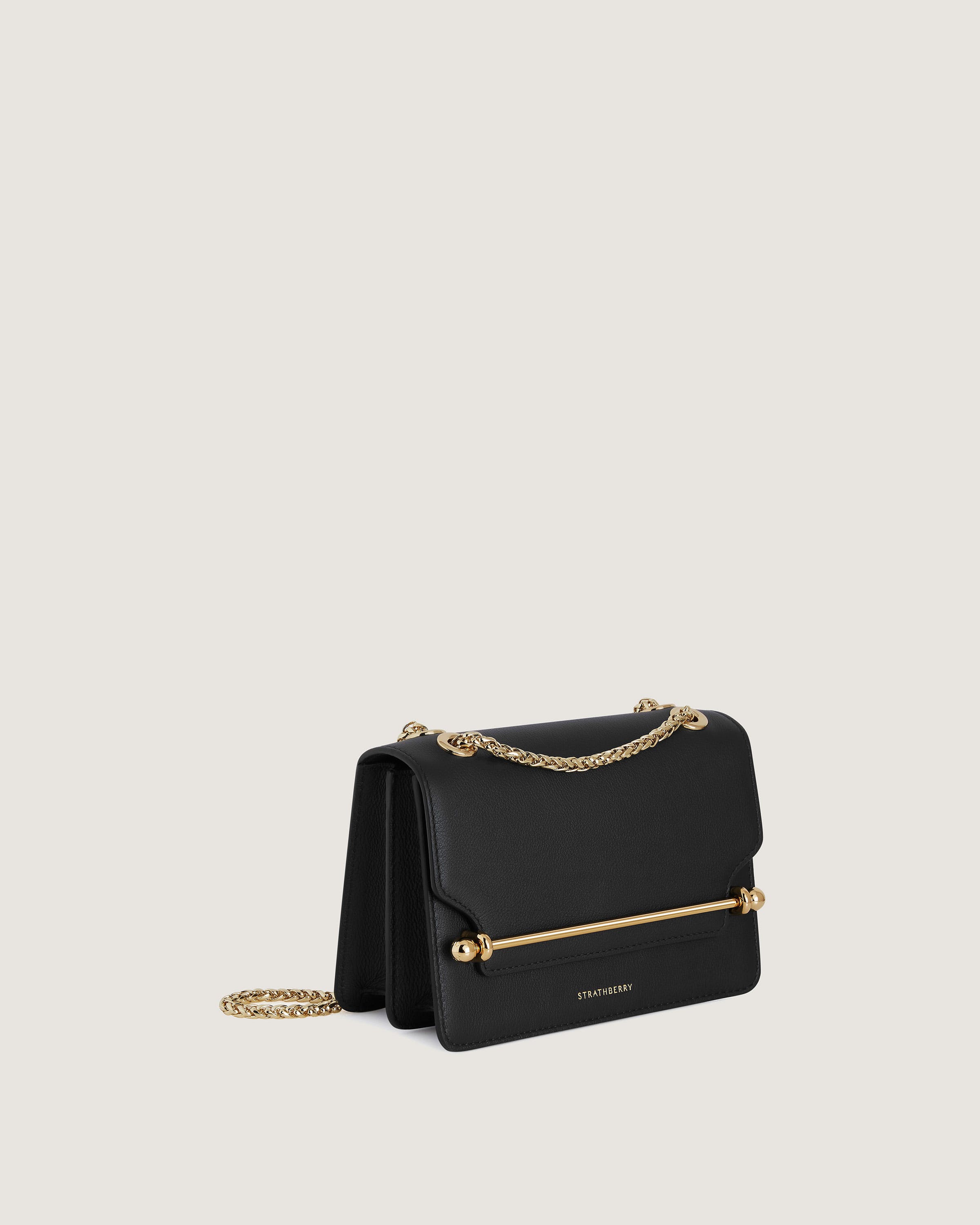 A black handbag with a gold chain strap