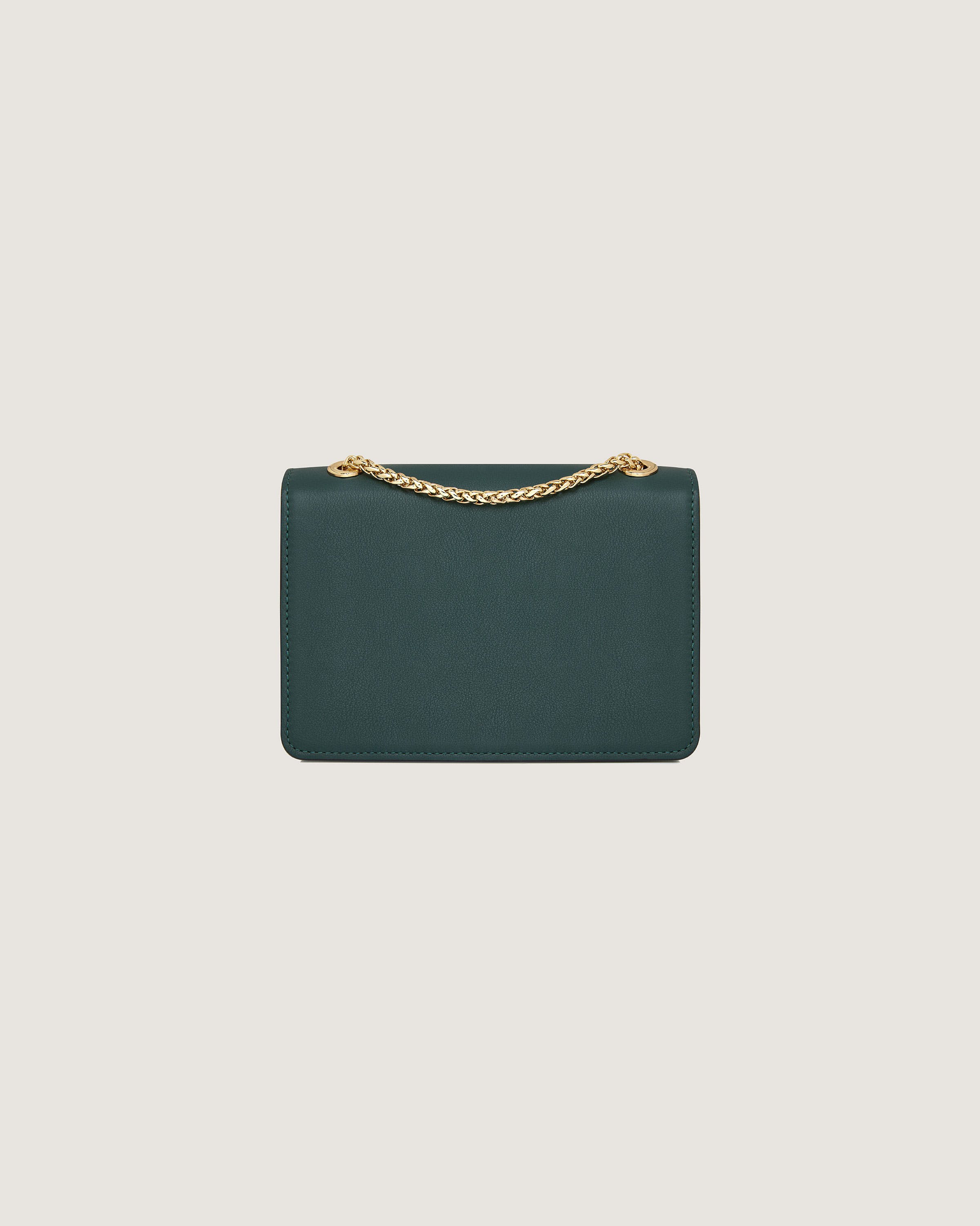 A small green purse with a gold chain