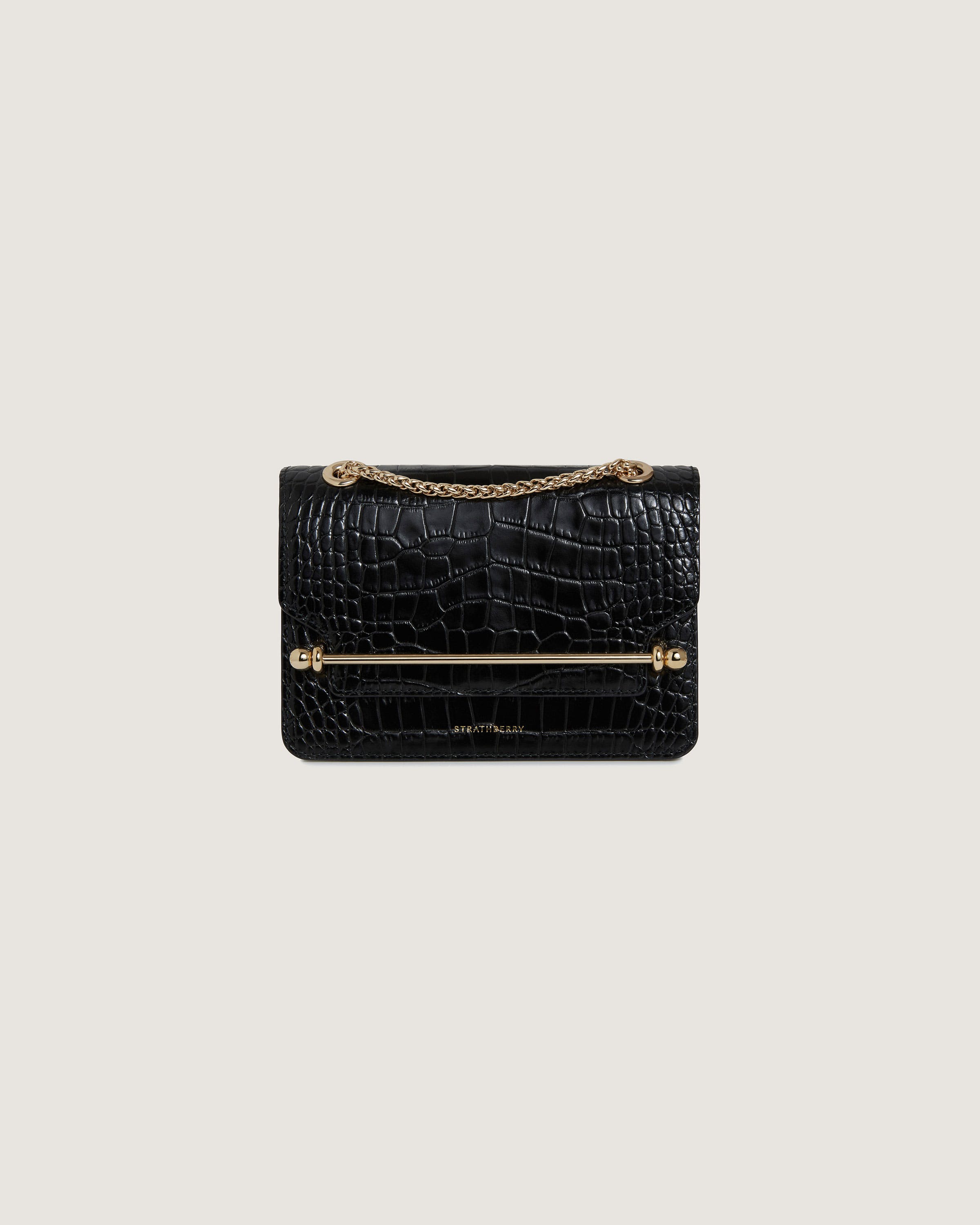 A black crocodile - embossed leather bag