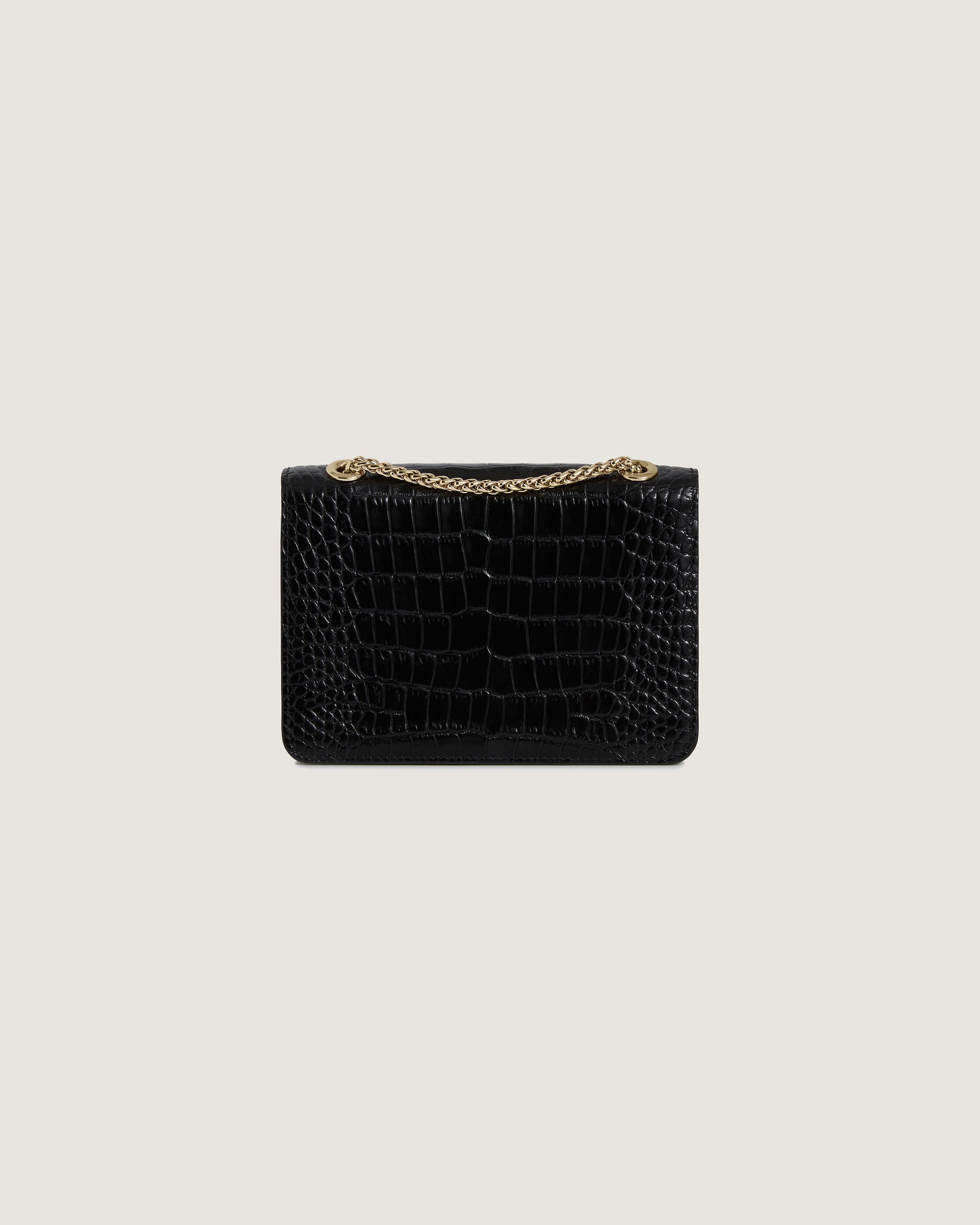 A black crocodile skin purse with a gold chain