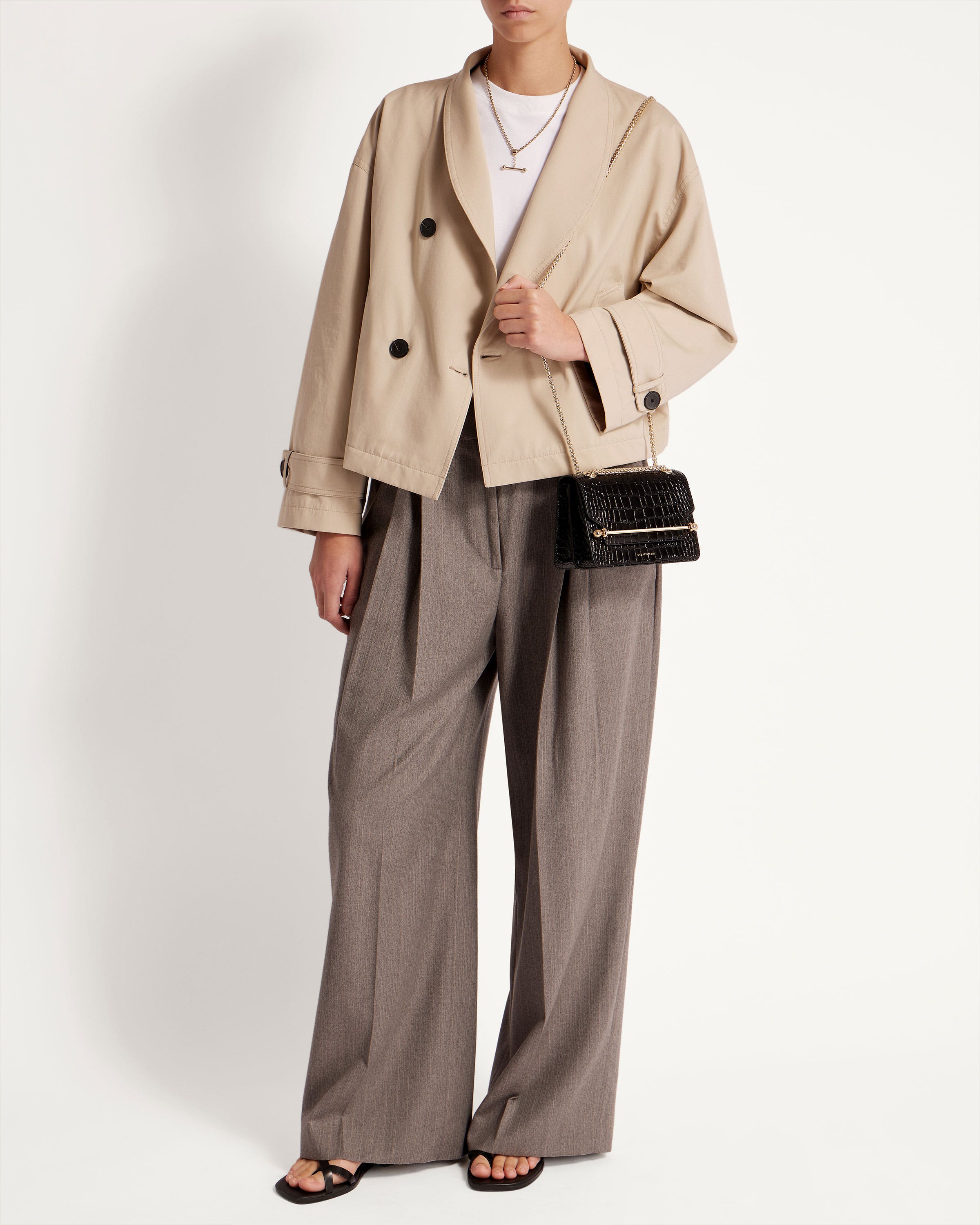 A woman in a trench coat and slacks