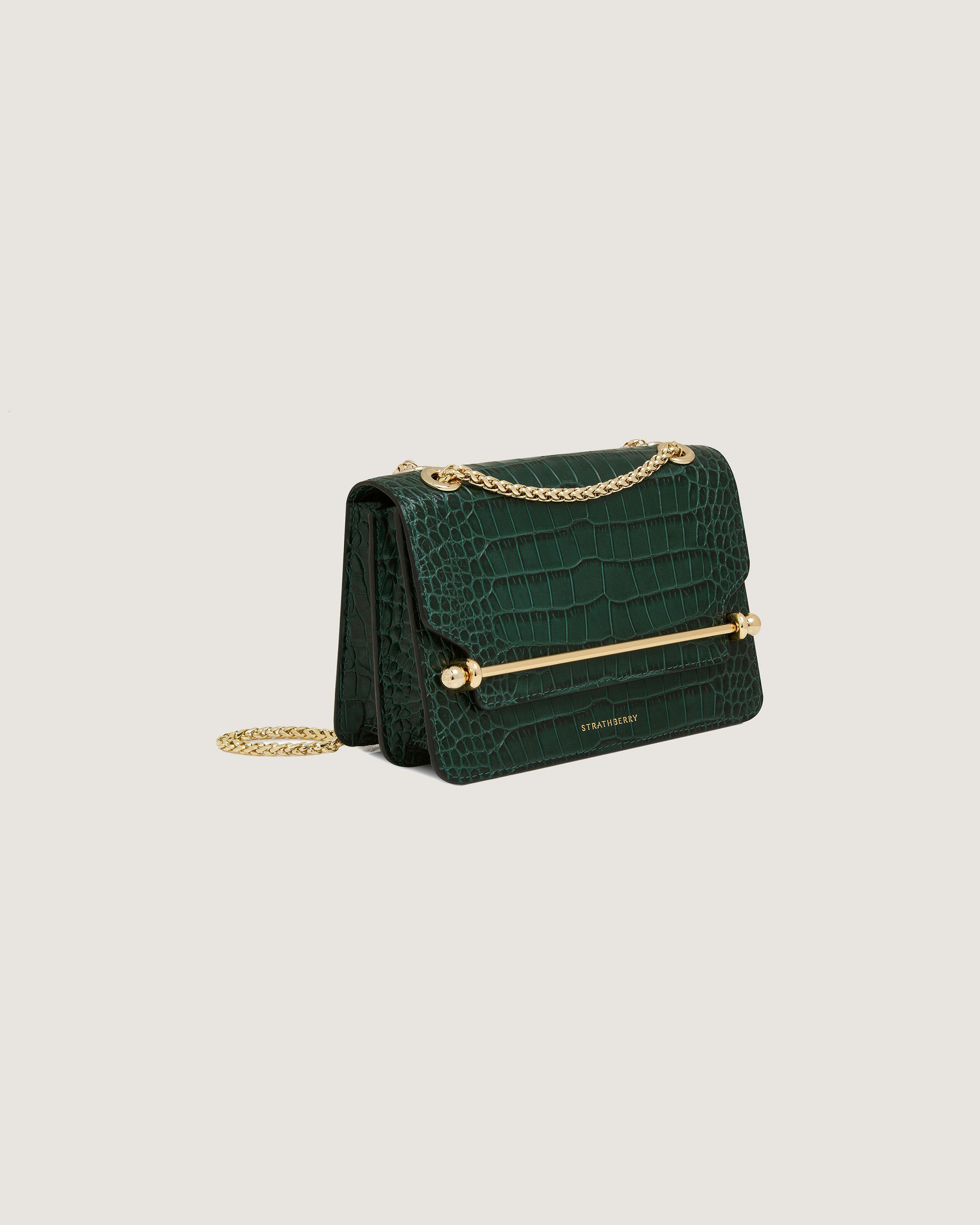 A green purse with a gold chain