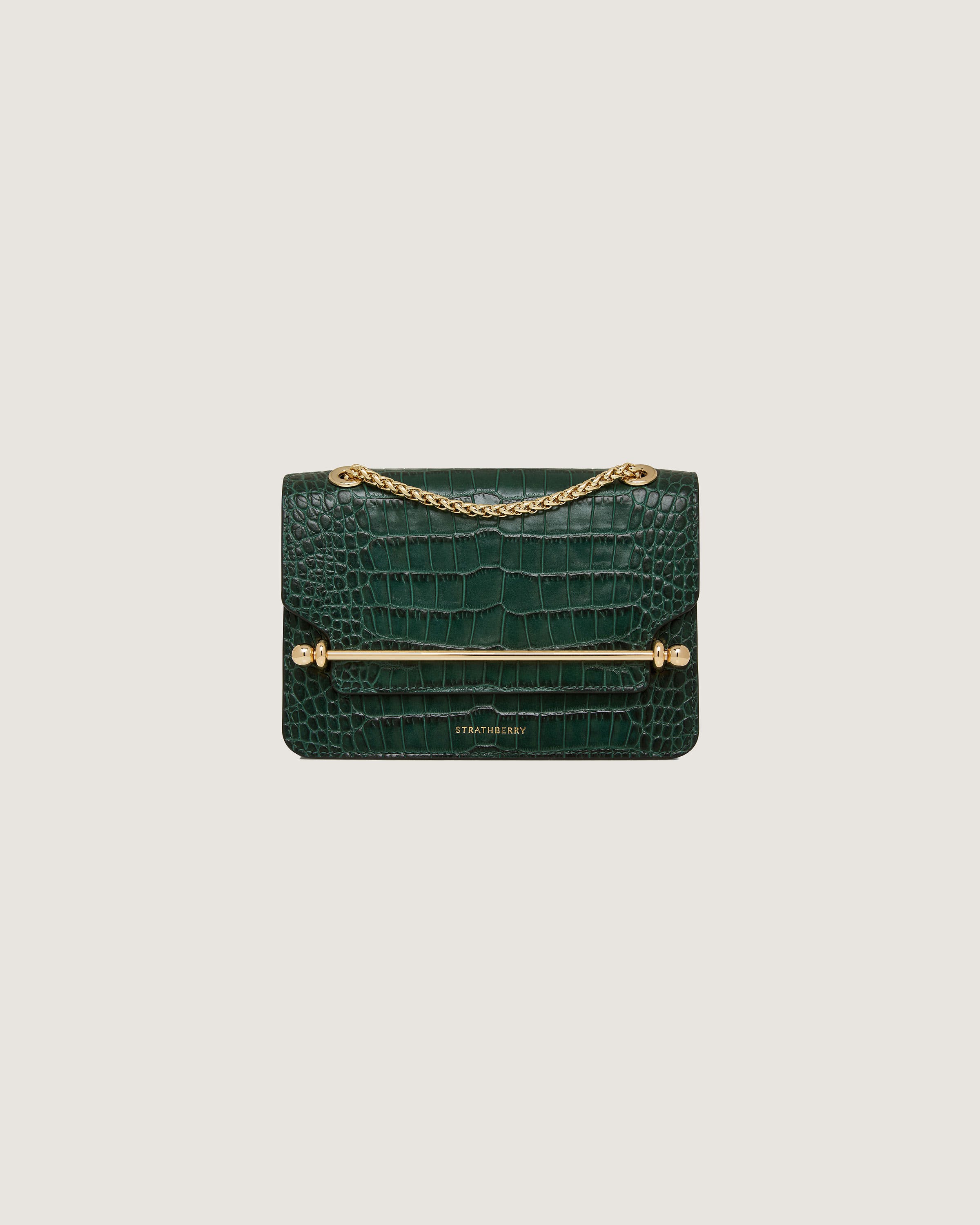 A green crocodile - embossed bag with a gold chain