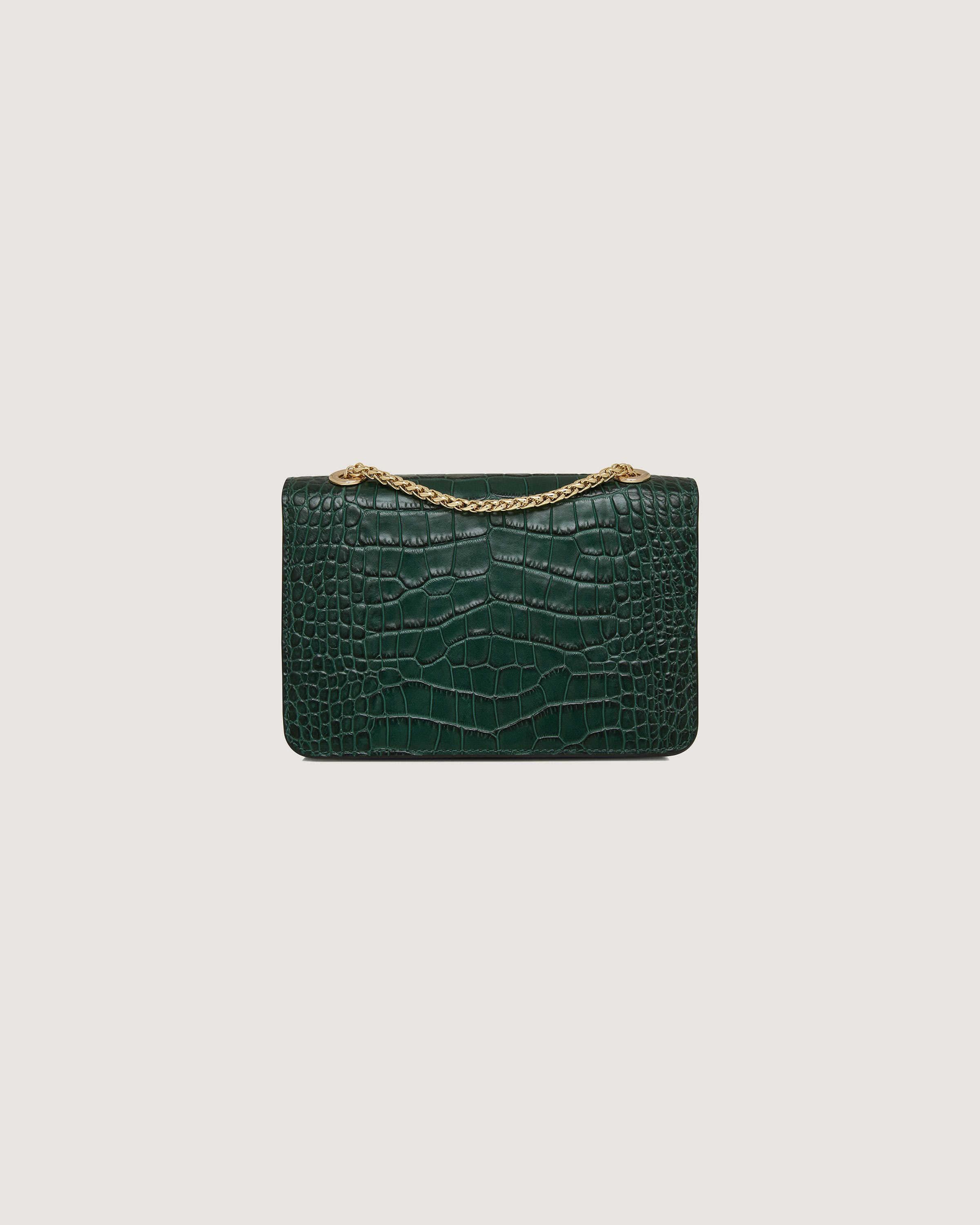 A green crocodile - embossed purse with a gold chain