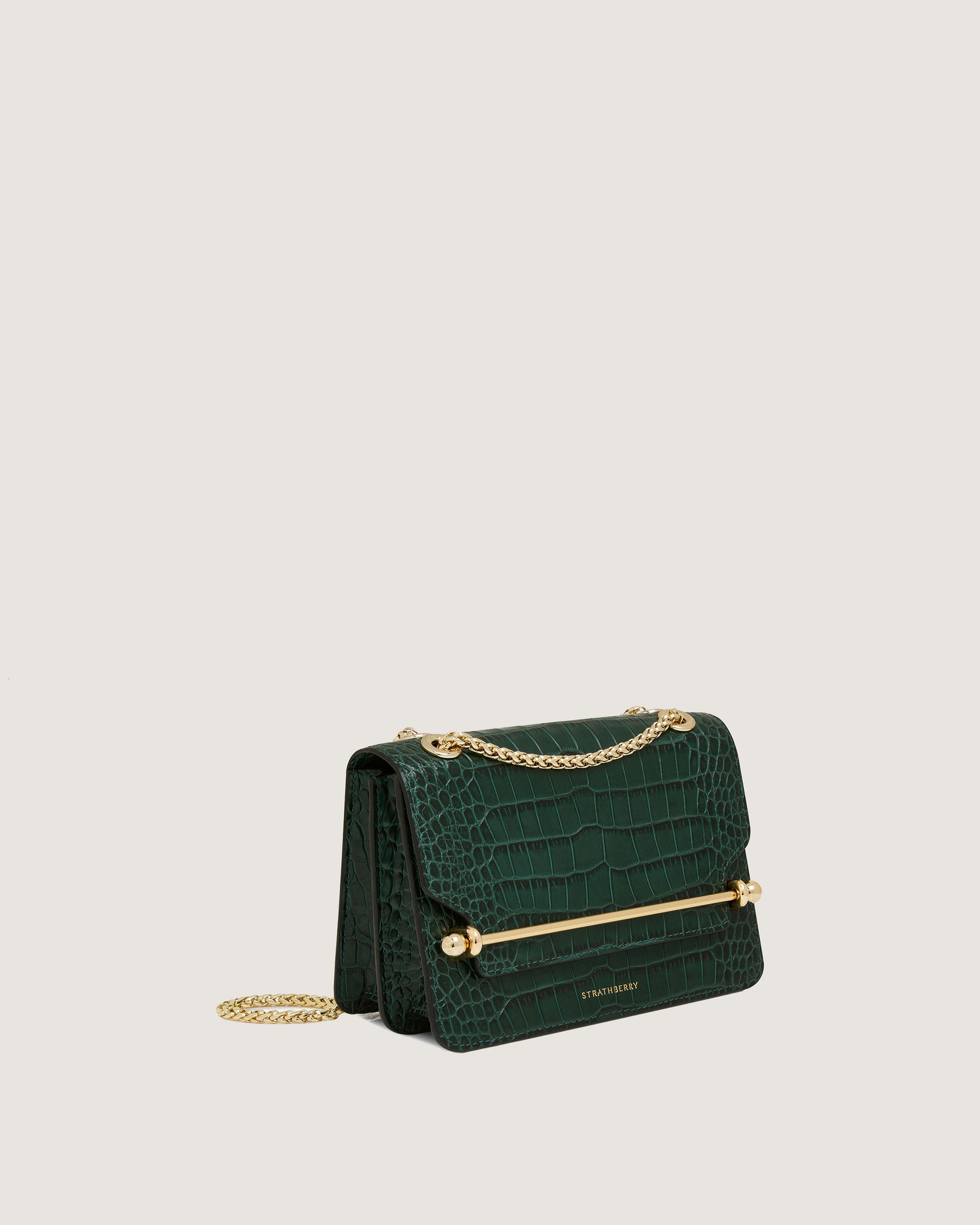 A green handbag with a gold chain