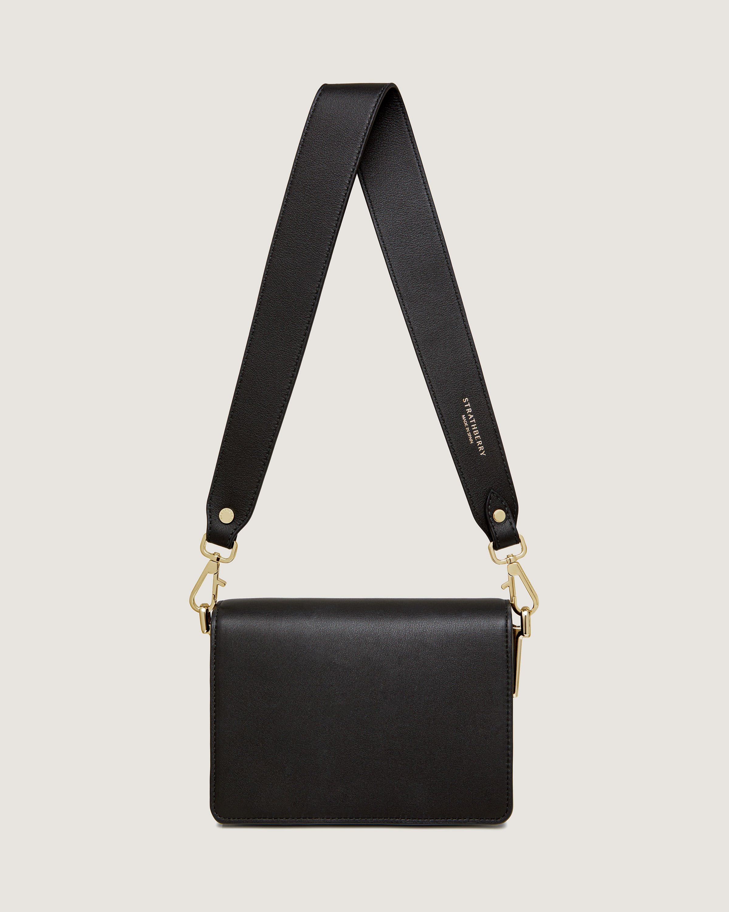 A black cross body bag on a white background