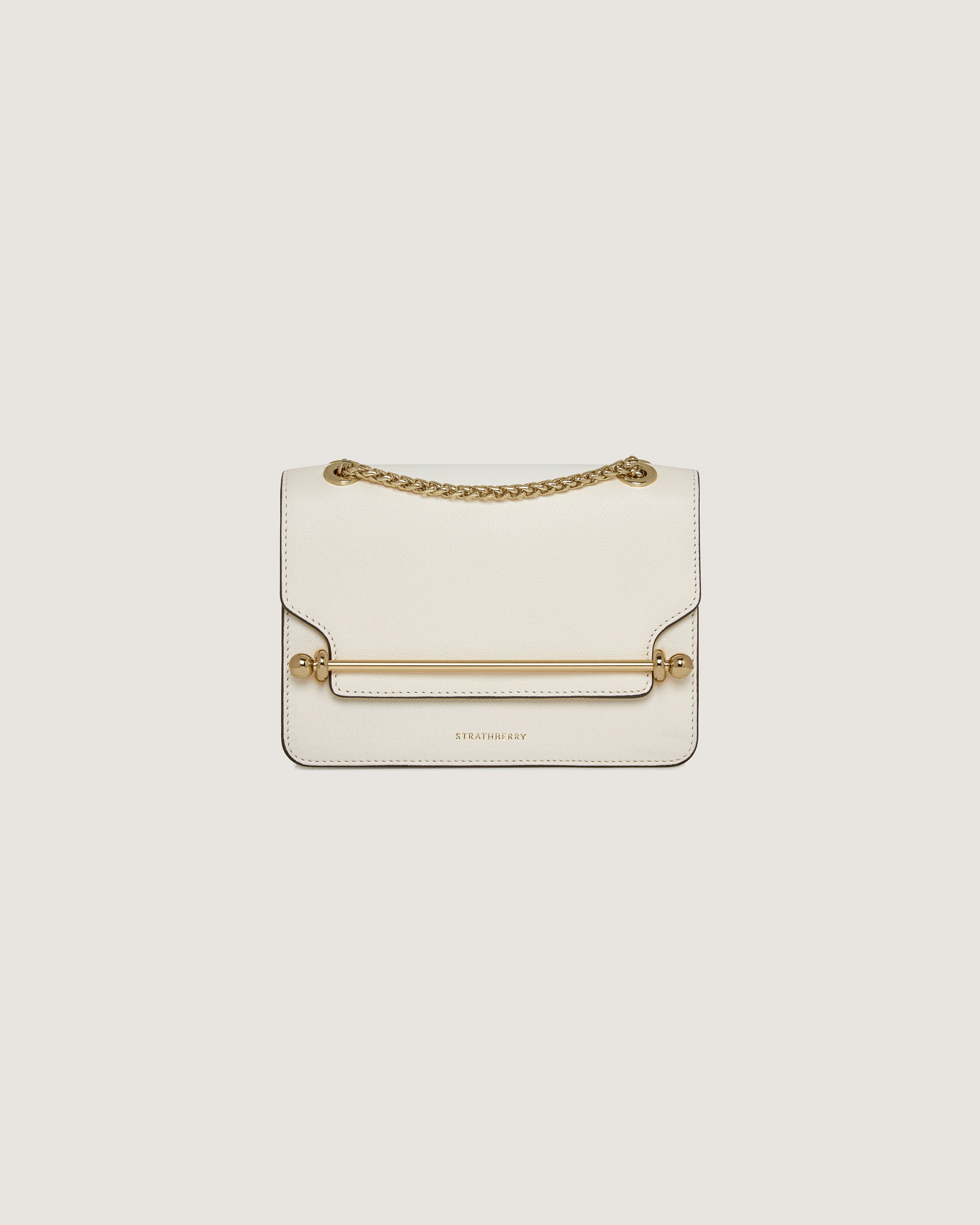 A white handbag with a gold chain