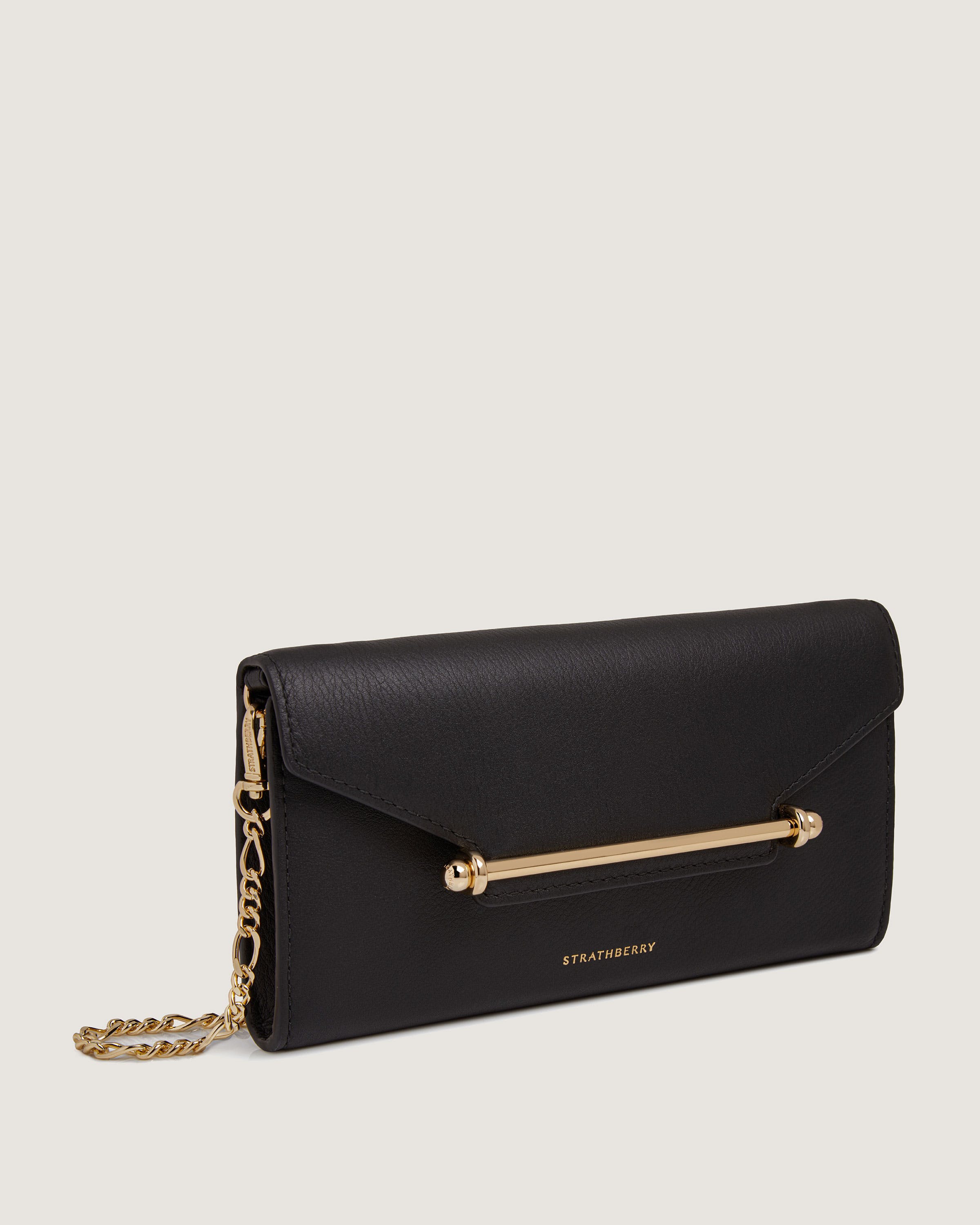 A black clutch bag with a gold chain