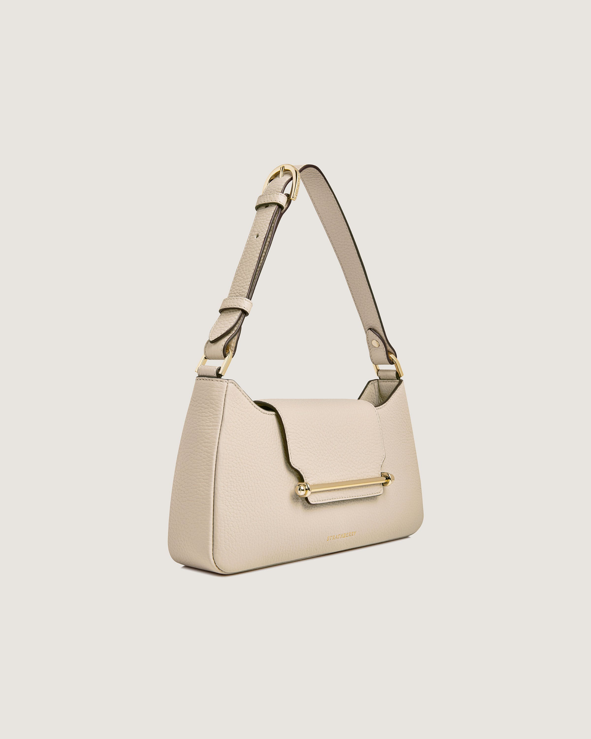 A white handbag with a gold handle