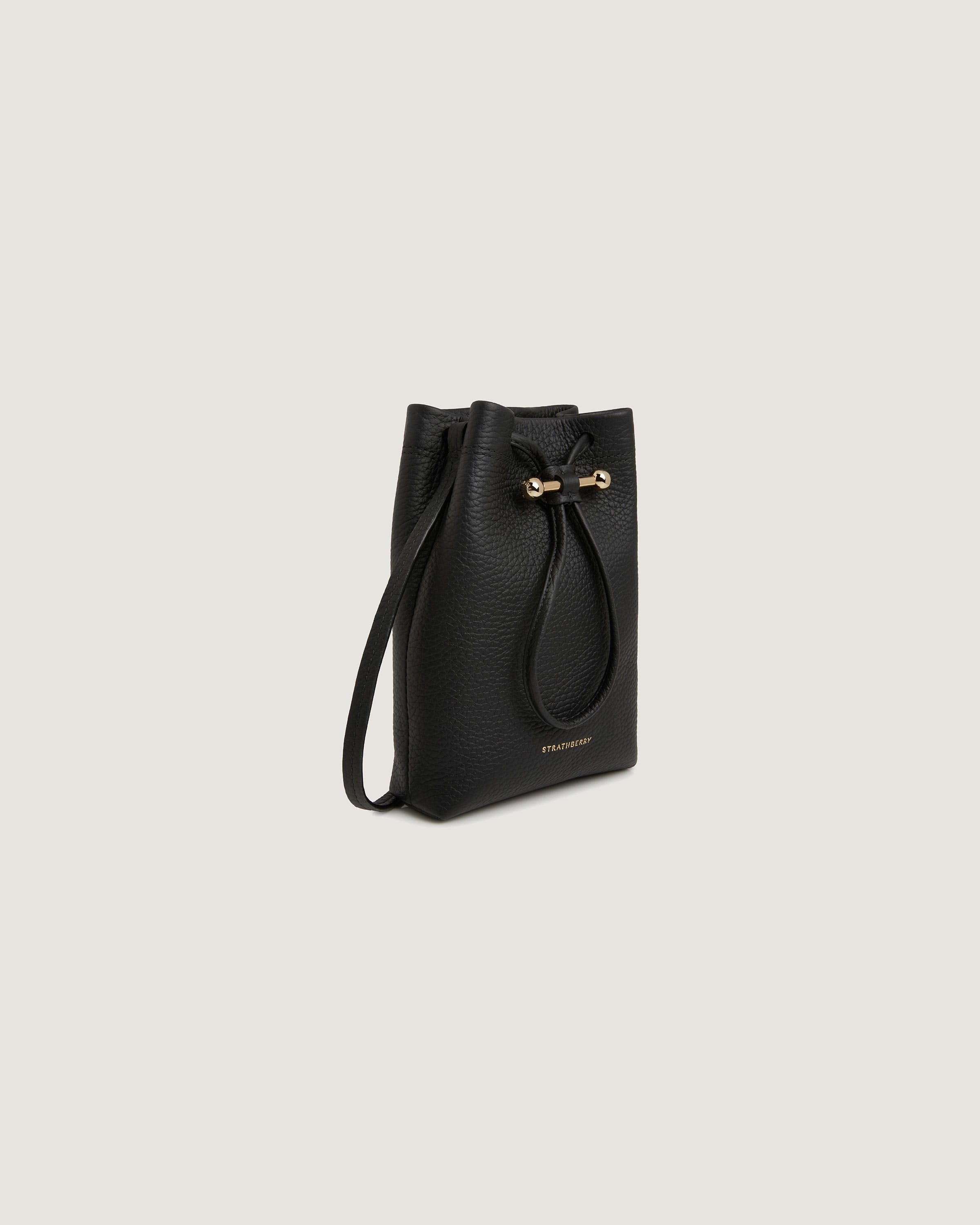 A black leather bucket bag with a bow