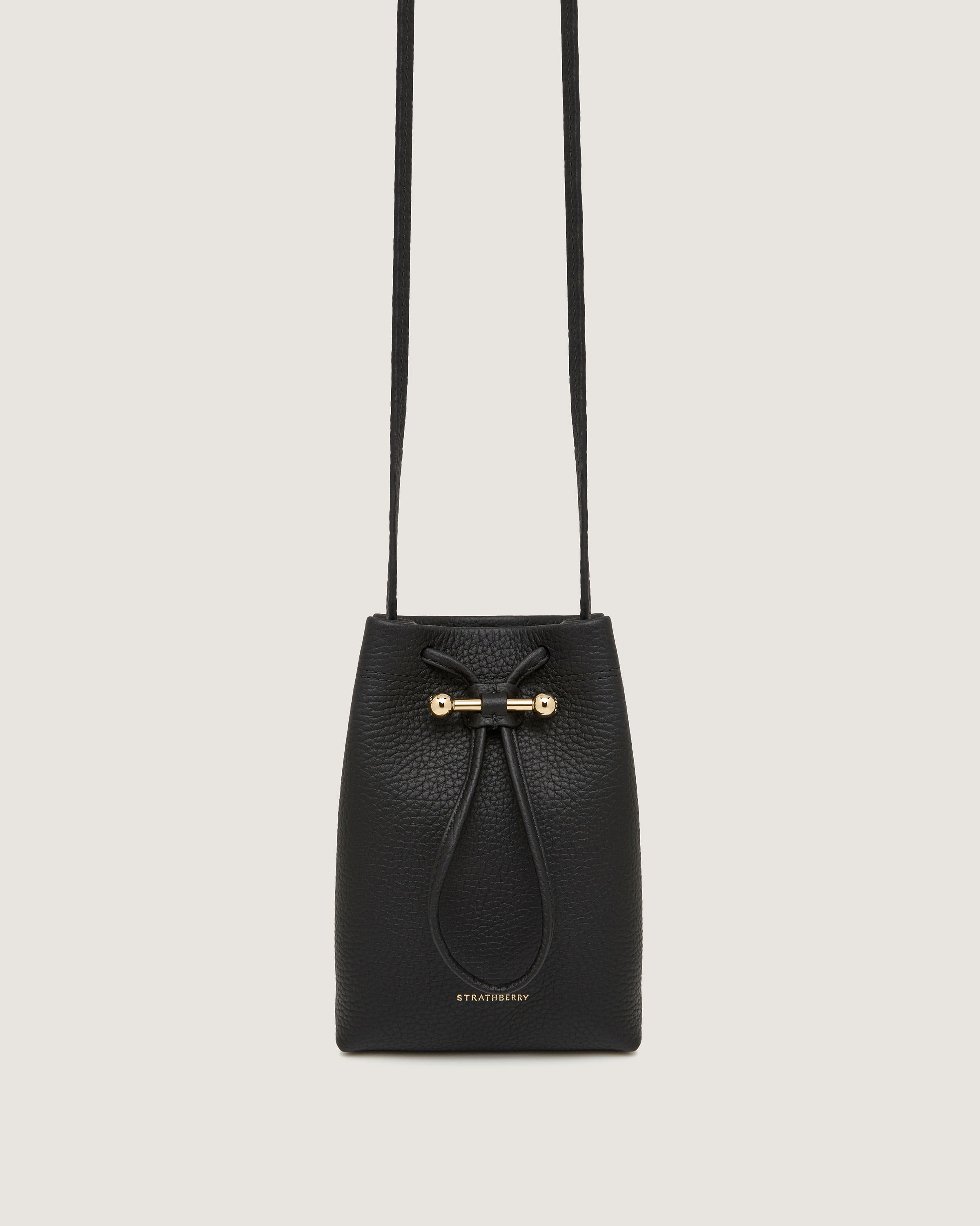 A black bucket bag with a bow on the front