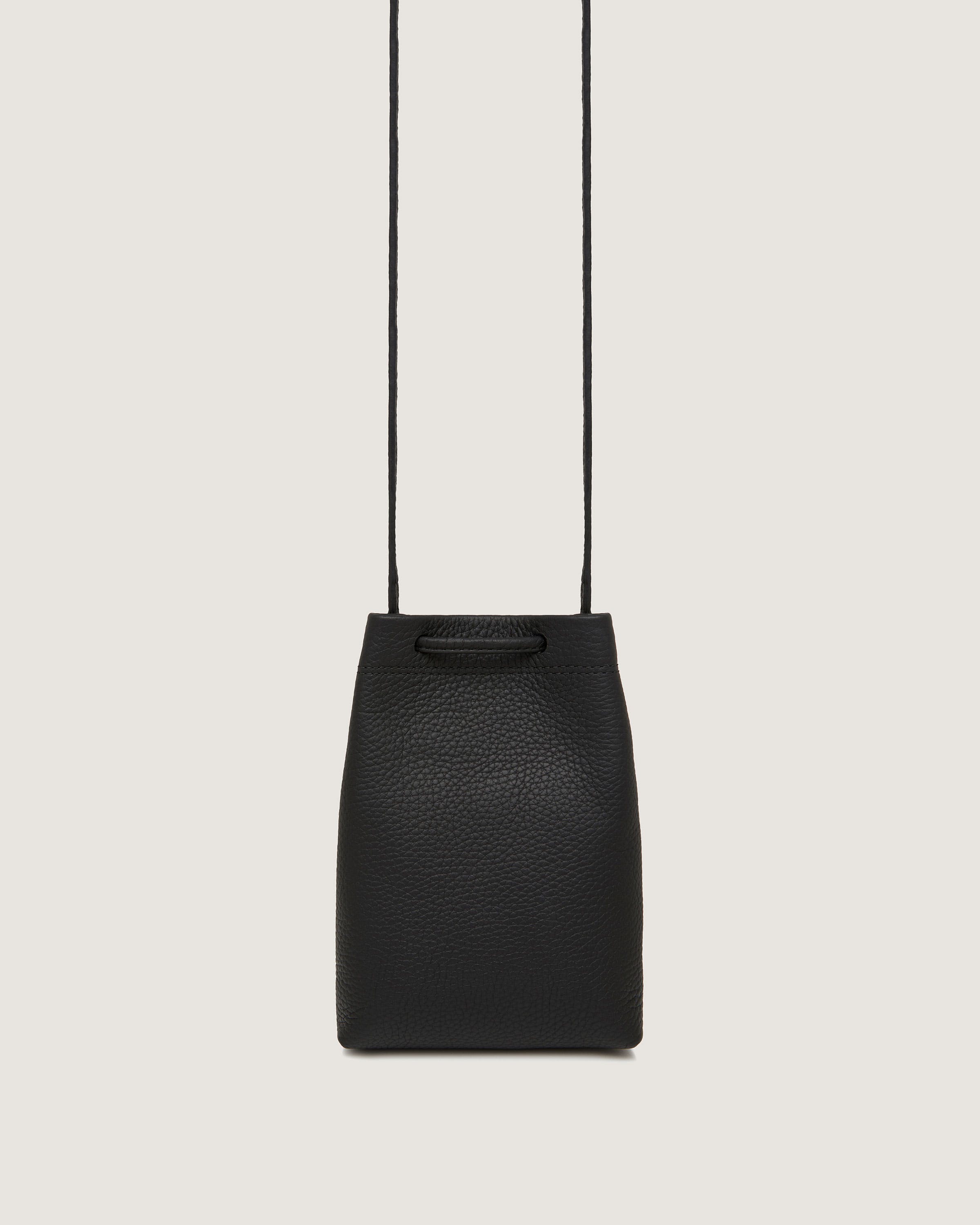 A black handbag hanging from a string