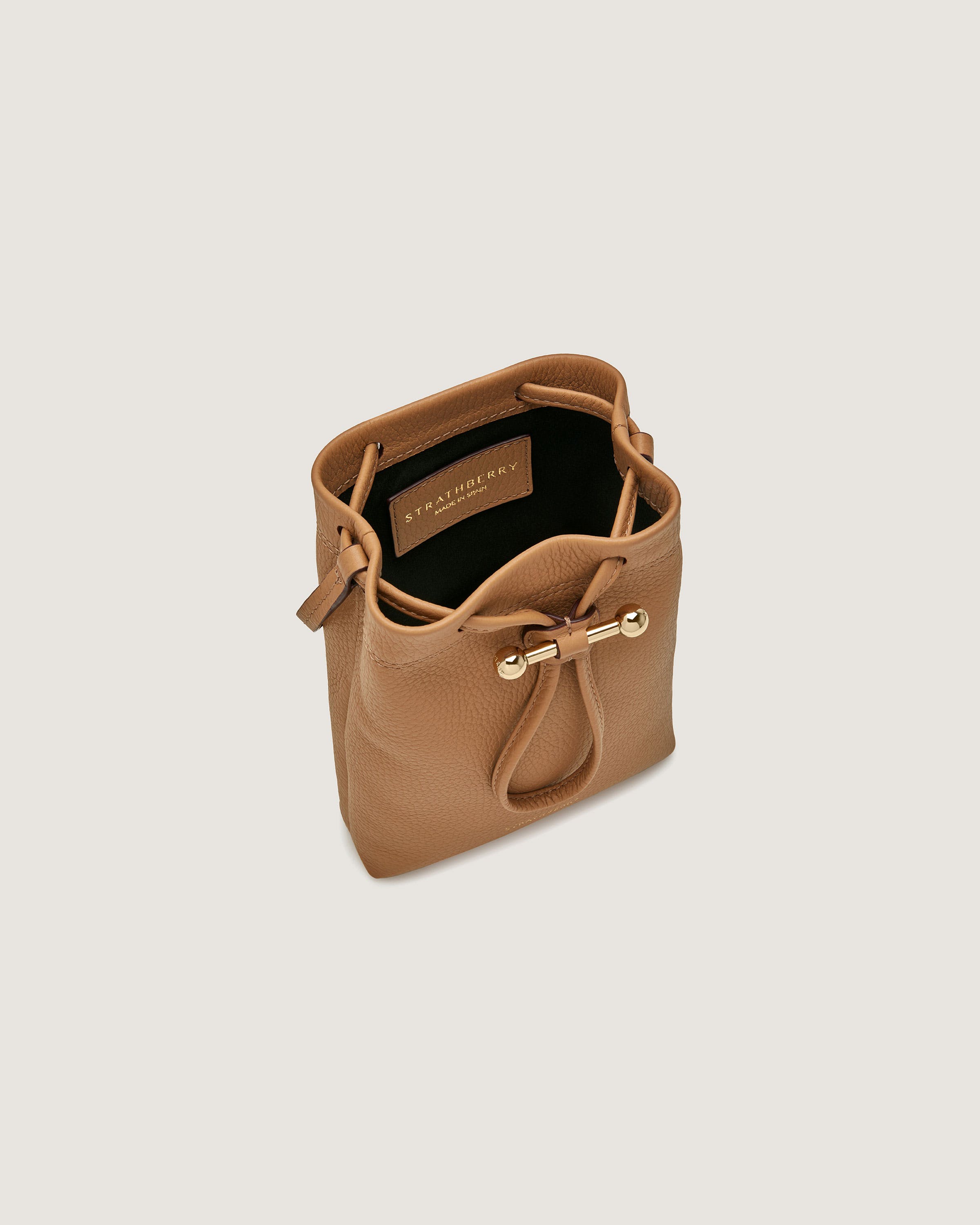 A tan leather handbag with a zipper