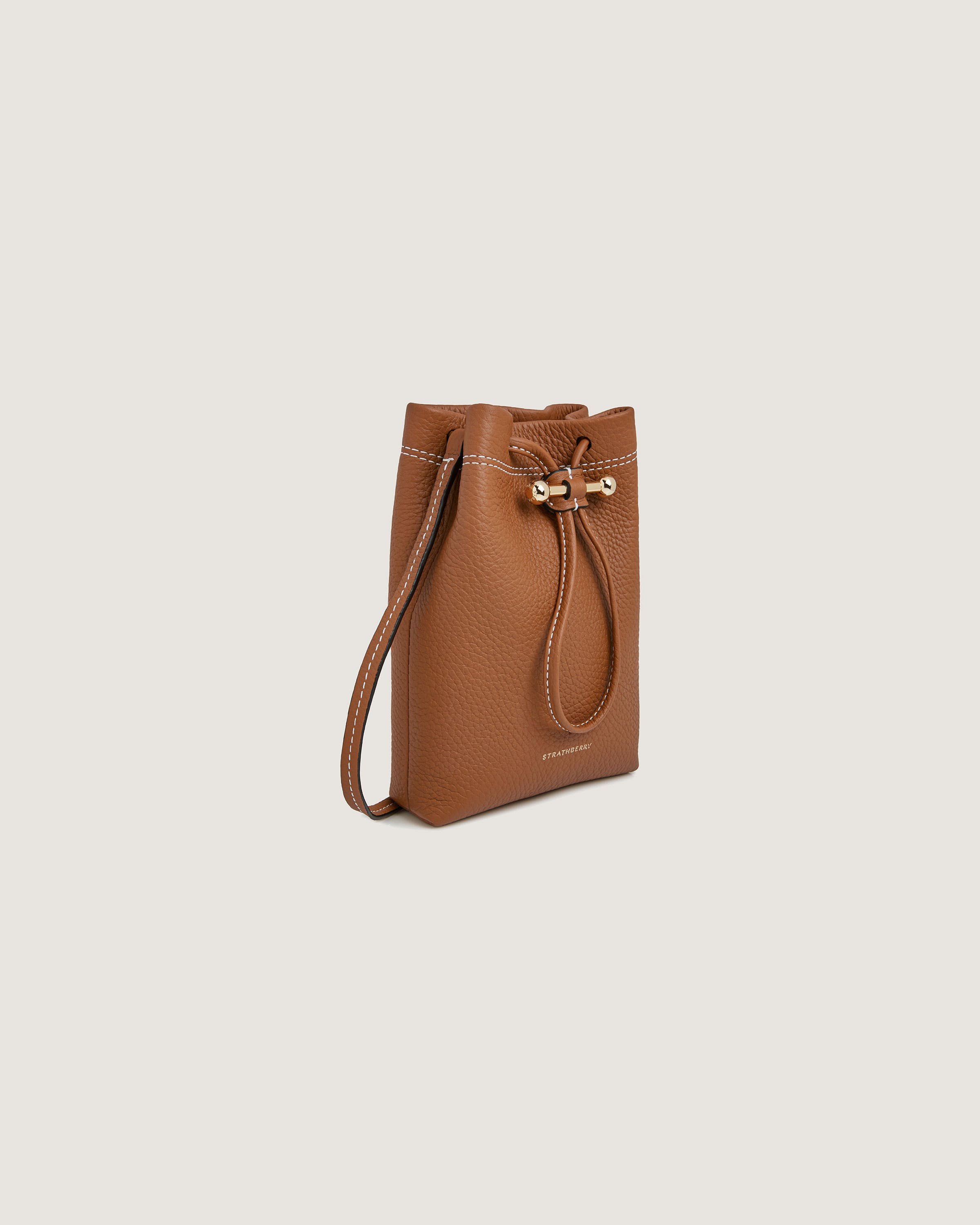 A brown leather bucket bag with a gold chain