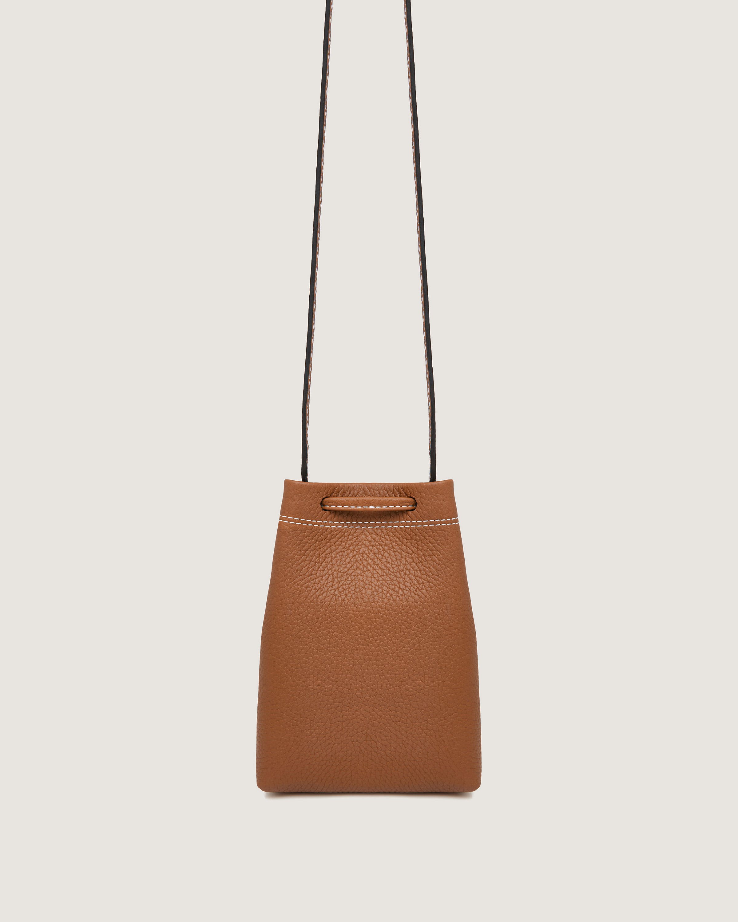 A brown handbag hanging from a black cord