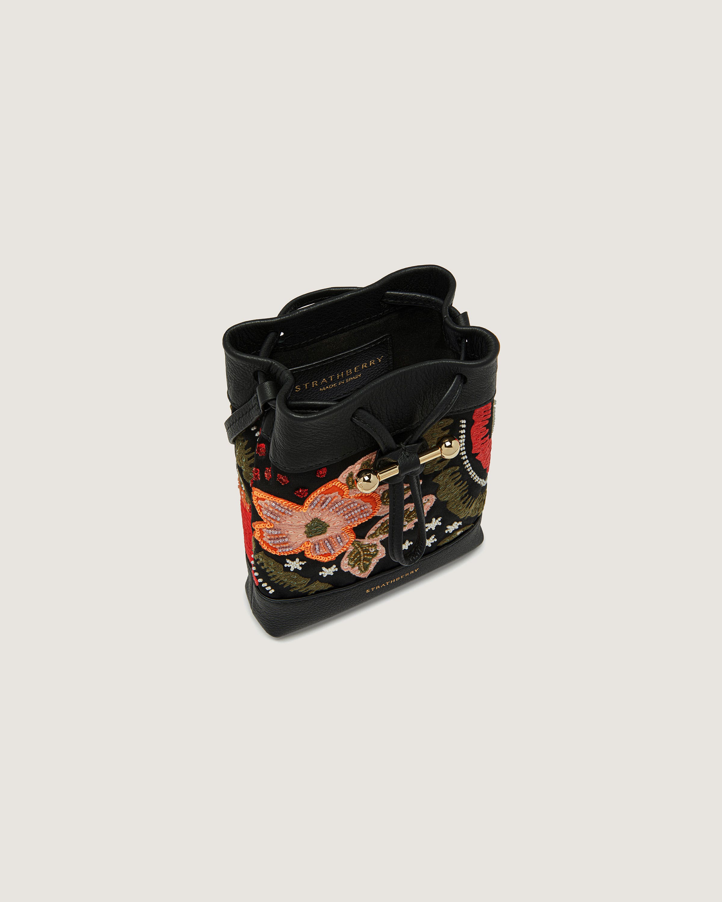 A black handbag with a dragon on it