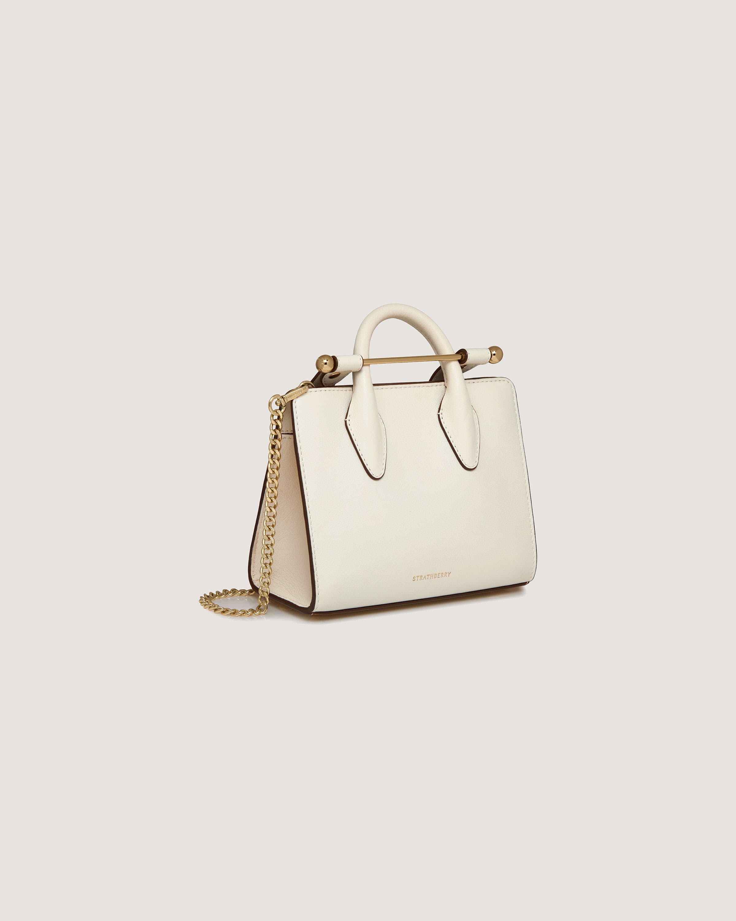 A white handbag with a chain strap