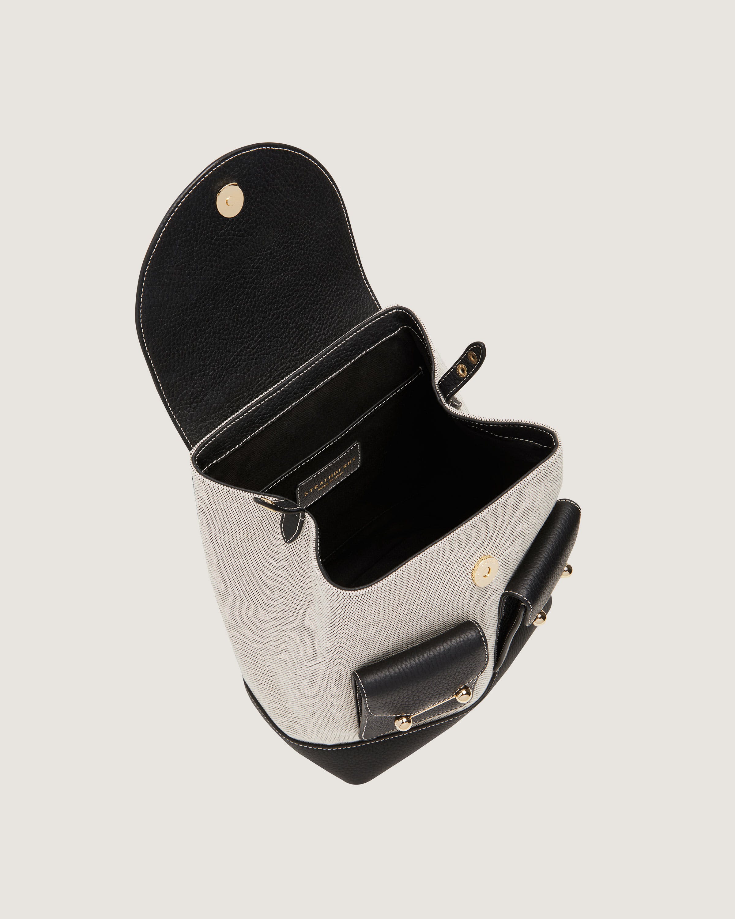 A black and white purse with a cell phone in it