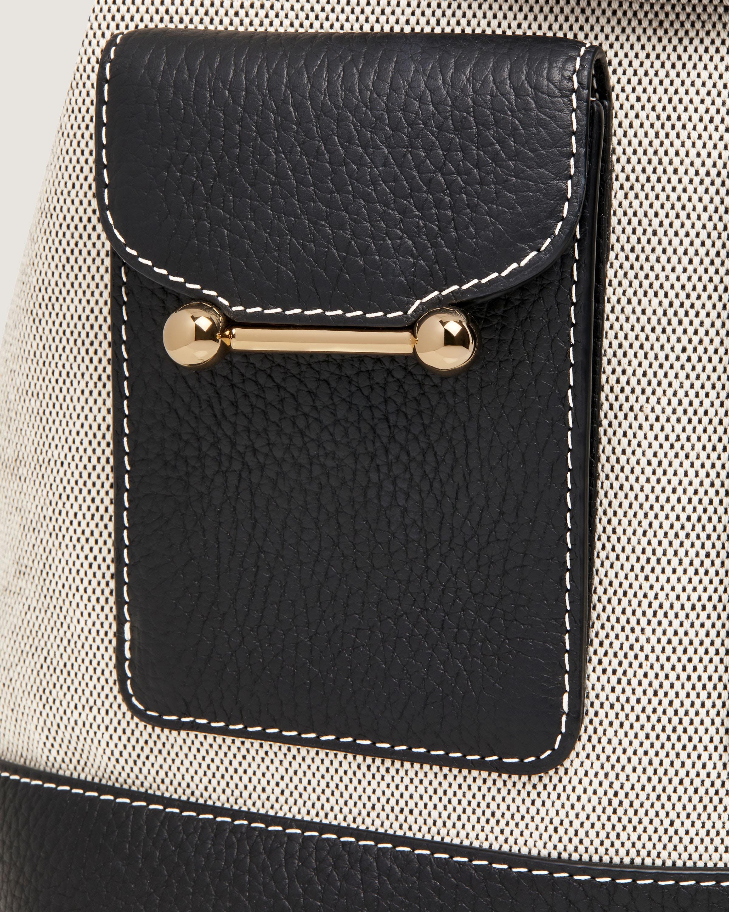 A close up of a black and white purse