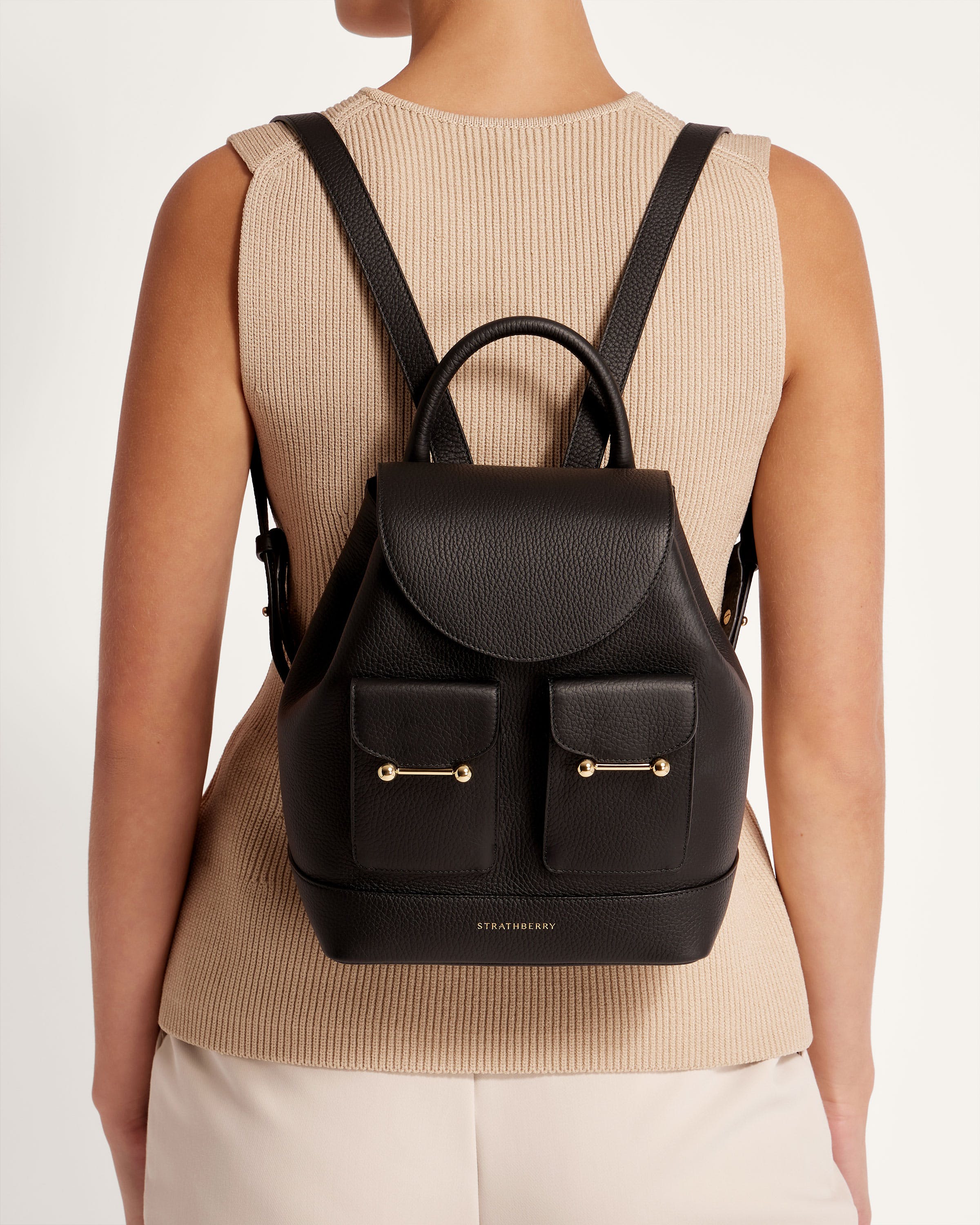 A woman wearing a black backpack with two pockets