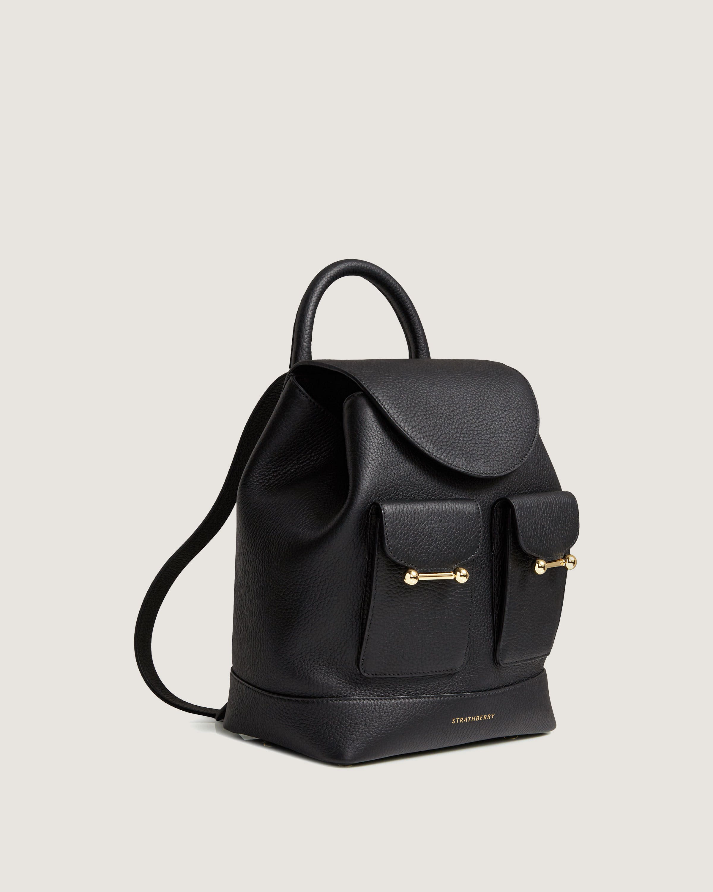 A black leather backpack with gold hardwares