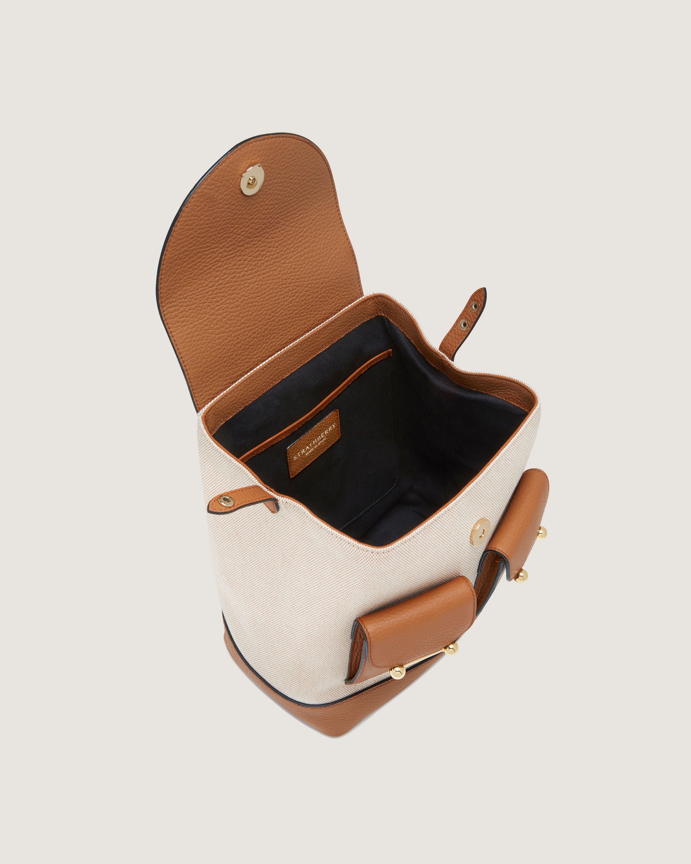 A white and brown purse with a brown handle